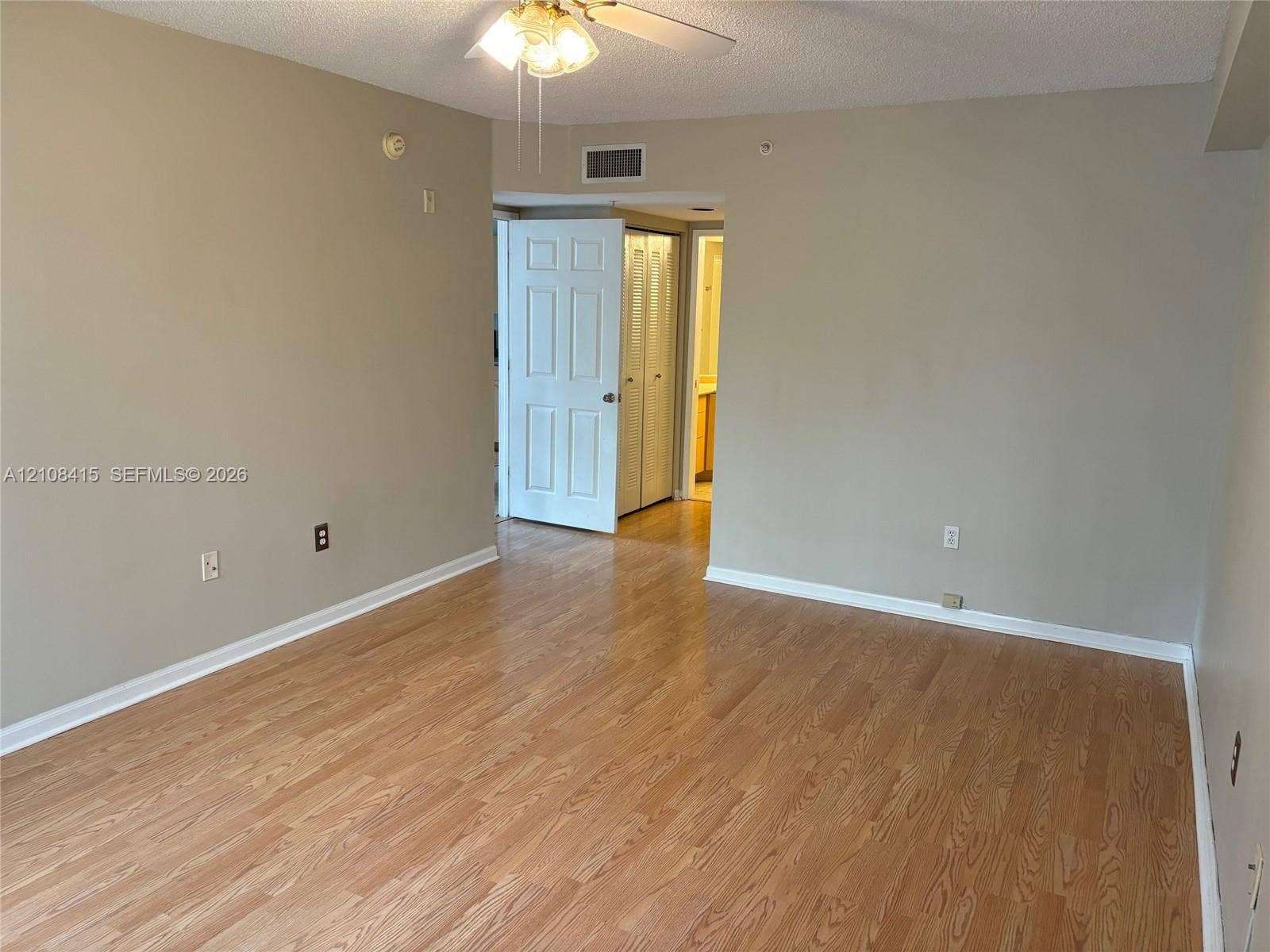 1900 Van Buren Street, #303B, Hollywood, Hollywood, FL 33020 Living area featuring wood-finish flooring, neutral wall paint, and a ceiling-mounted light fixture