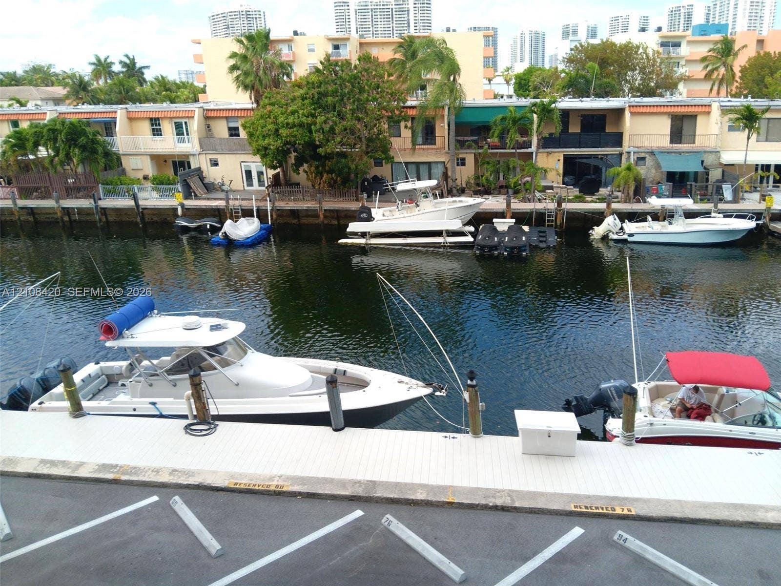 3545 NE 166th Street, #306, North Miami Beach, FL 33160 Waterfront property featuring a private concrete dock, deep-water access, and designated mooring space