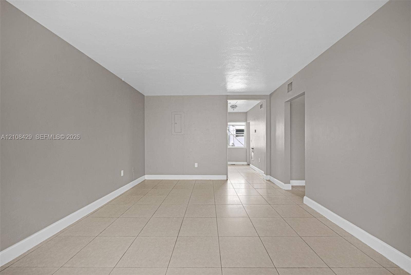 1430 NE 171st Street, North Miami Beach, FL 33162 Interior space featuring neutral-toned wall paint and oversized tile flooring