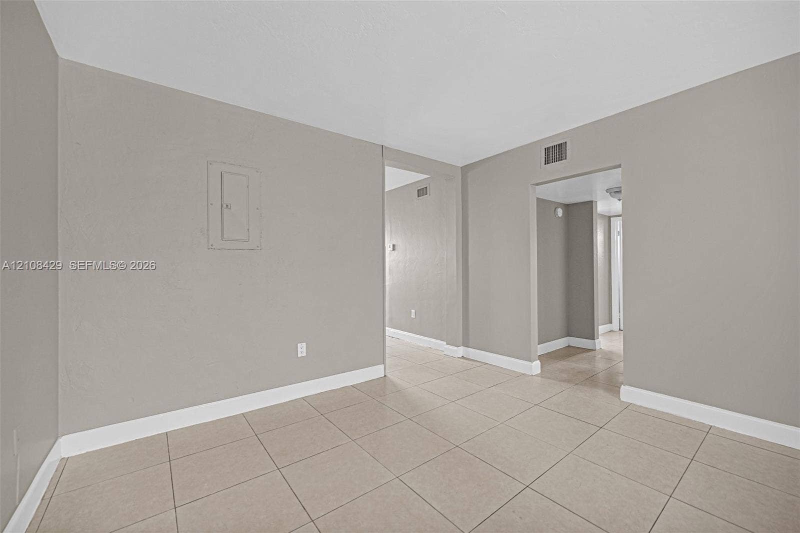 1430 NE 171st Street, North Miami Beach, FL 33162 Interior space featuring neutral-toned walls, tile flooring, and recessed doorway openings