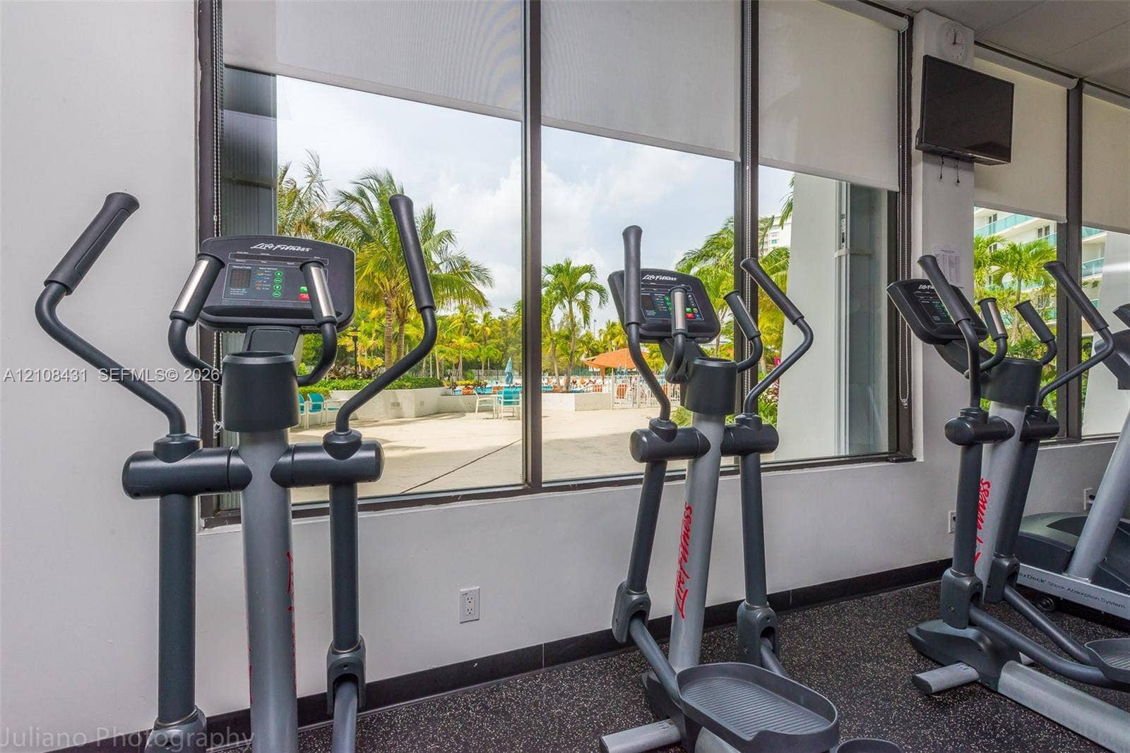 100 Bayview Drive, #1904, Sunny Isles Beach, Sunny Isles Beach, FL 33160 Fitness center featuring floor-to-ceiling windows, retractable solar shades, and industrial rubber flooring