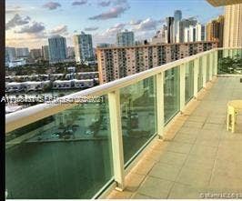 100 Bayview Drive, #1904, Sunny Isles Beach, Sunny Isles Beach, FL 33160 Private balcony featuring tile flooring and a glass-panel railing