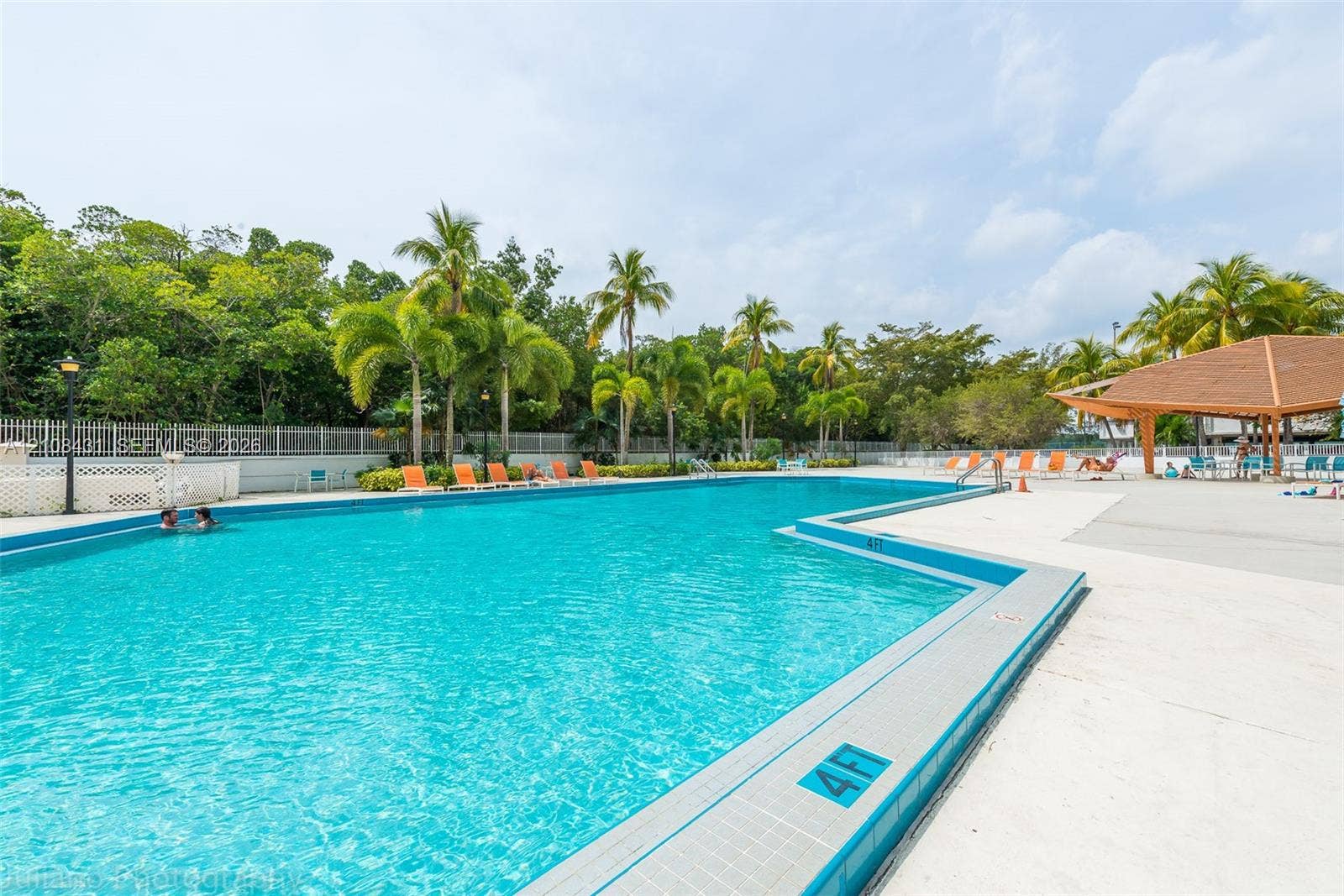 100 Bayview Drive, #1904, Sunny Isles Beach, Sunny Isles Beach, FL 33160 In-ground swimming pool with a tiled perimeter, expansive concrete deck, covered pavilion, and mature perimeter landscaping