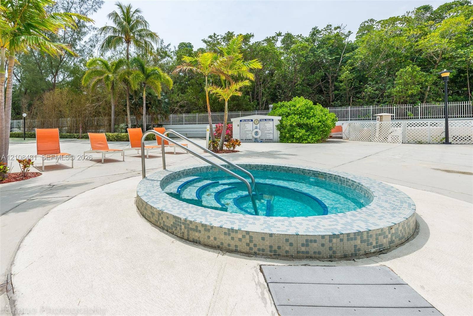 100 Bayview Drive, #1904, Sunny Isles Beach, Sunny Isles Beach, FL 33160 Circular jetted spa featuring a tile-accented exterior, built-in entry steps, stainless steel handrail, and a surrounding concrete deck