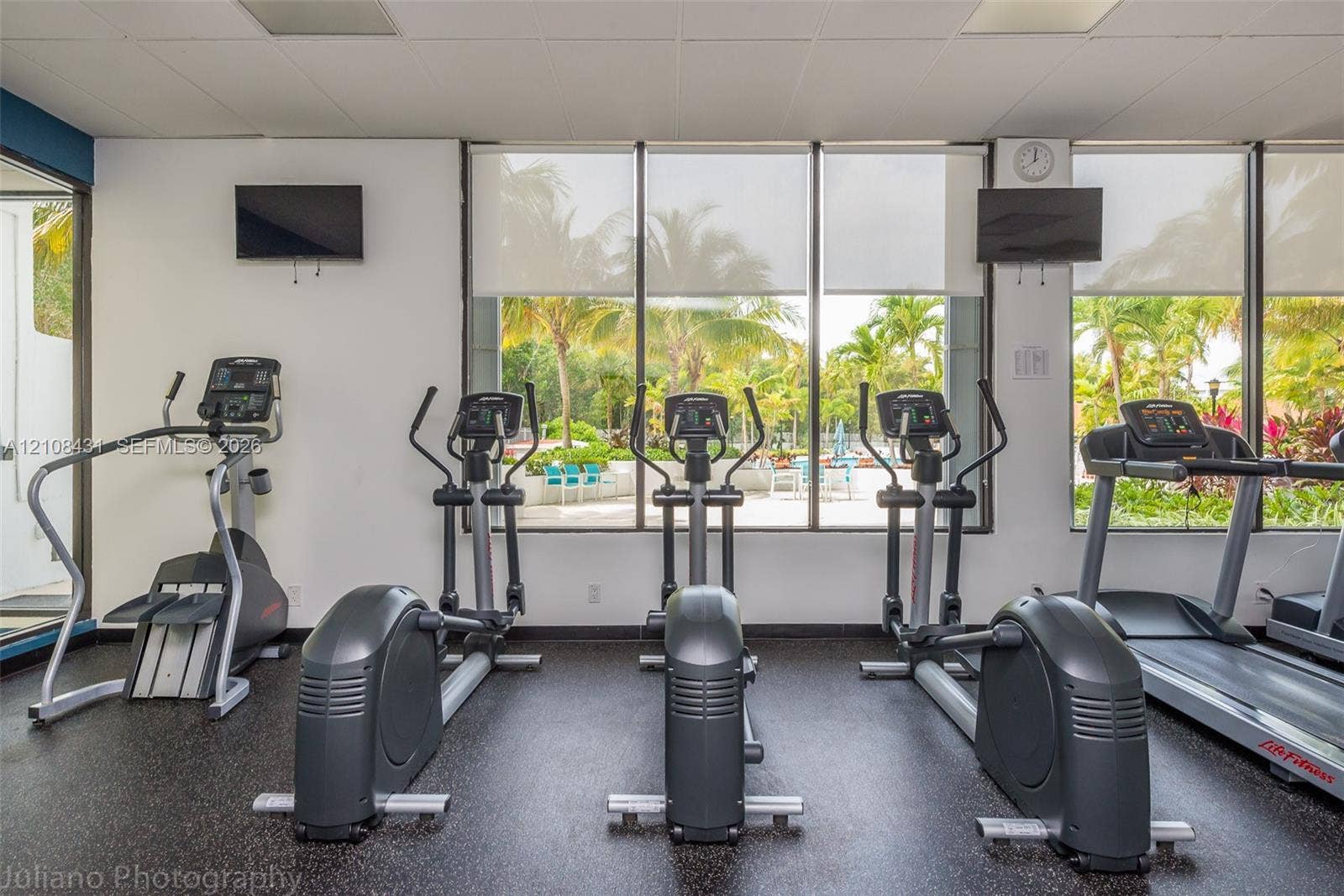 100 Bayview Drive, #1904, Sunny Isles Beach, Sunny Isles Beach, FL 33160 Fitness center featuring floor-to-ceiling windows, rubberized flooring, and wall-mounted televisions
