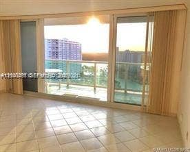 100 Bayview Drive, #1904, Sunny Isles Beach, Sunny Isles Beach, FL 33160 Floor-to-ceiling sliding glass doors, private glass-railed balcony, and large-format tile flooring