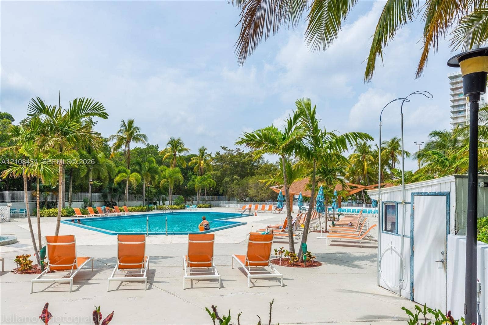 100 Bayview Drive, #1904, Sunny Isles Beach, Sunny Isles Beach, FL 33160 Swimming pool with concrete decking, palm tree landscaping, and a covered pavilion