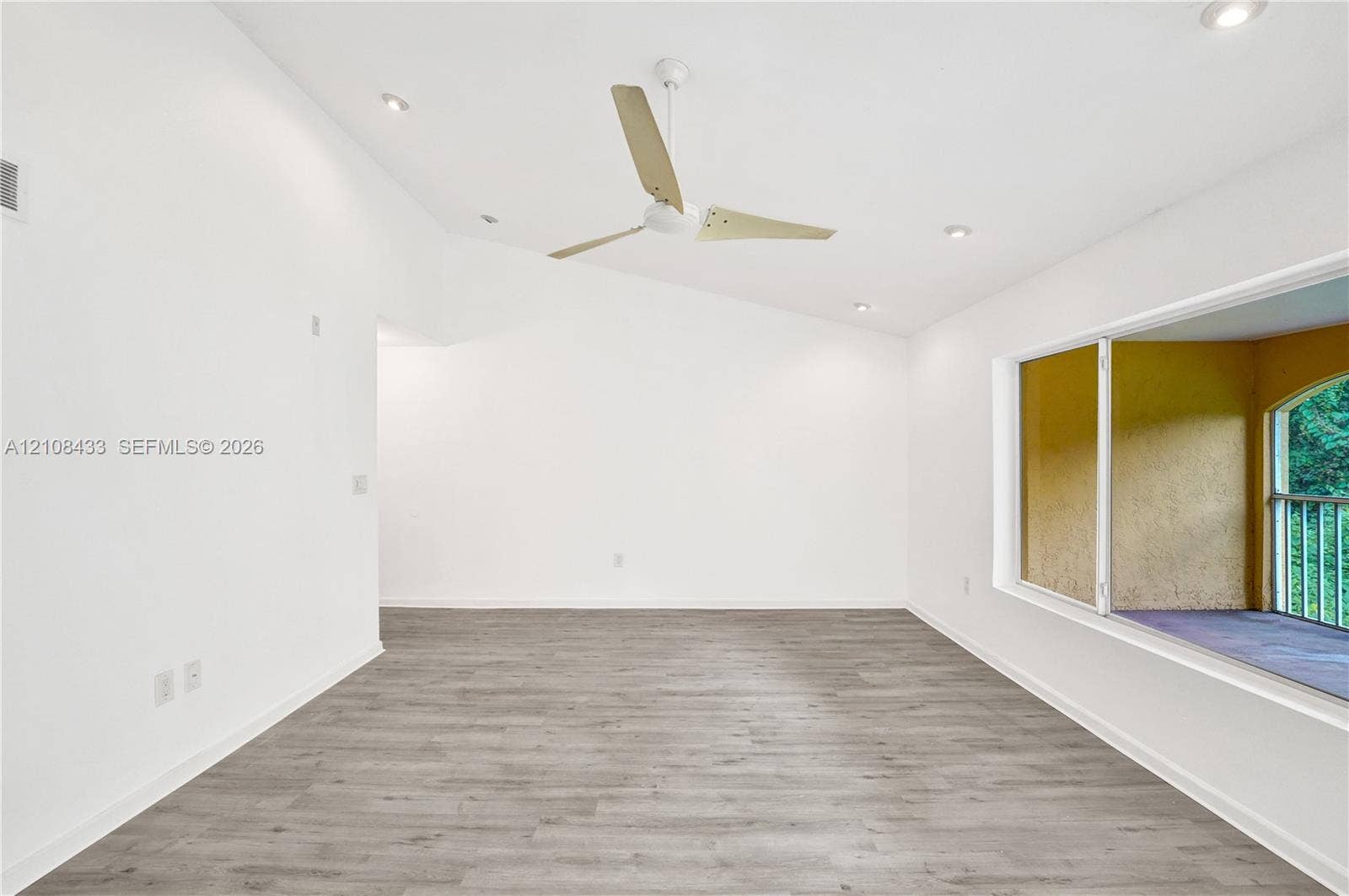 2300 NW 33rd Street, #911, Oakland Park, FL 33309 Vaulted ceiling with recessed lighting, wood-finish flooring, and a modern three-blade ceiling fan