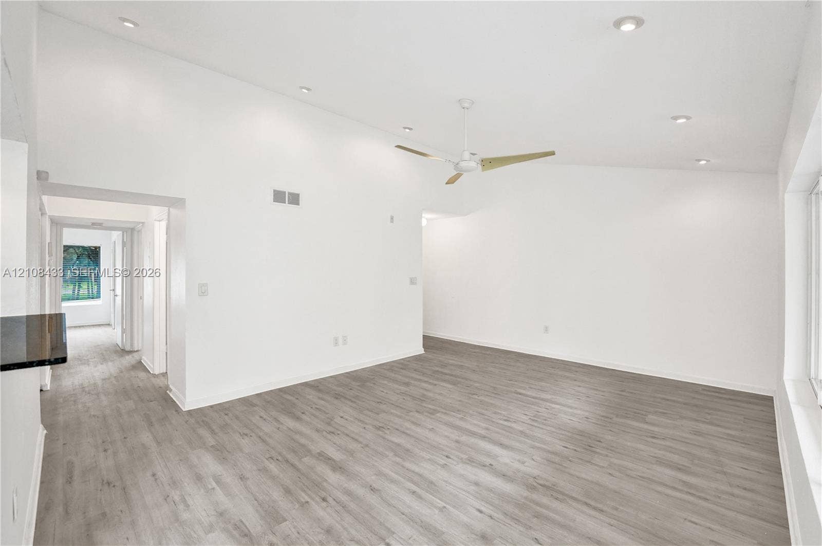 2300 NW 33rd Street, #911, Oakland Park, FL 33309 Vaulted ceilings featuring recessed lighting, a modern ceiling fan, and wood-finish flooring