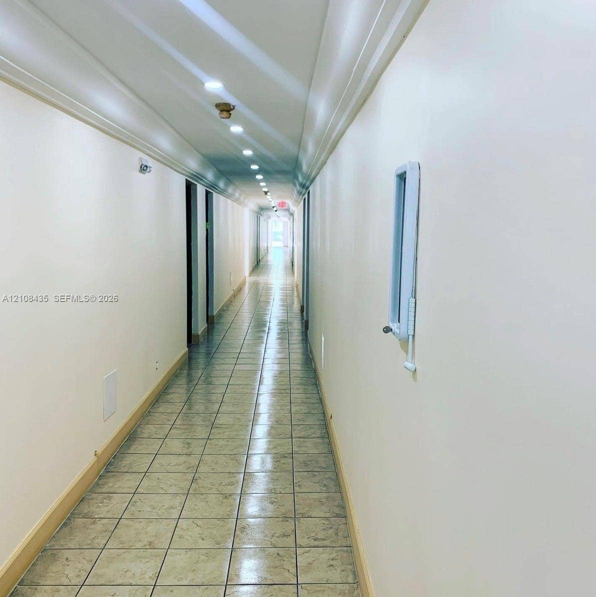 4275 S Tamiami Canal Drive, #2-314, Miami, Miami, FL 33126 Hallway featuring neutral wall finishes, tile flooring, and recessed ceiling lighting