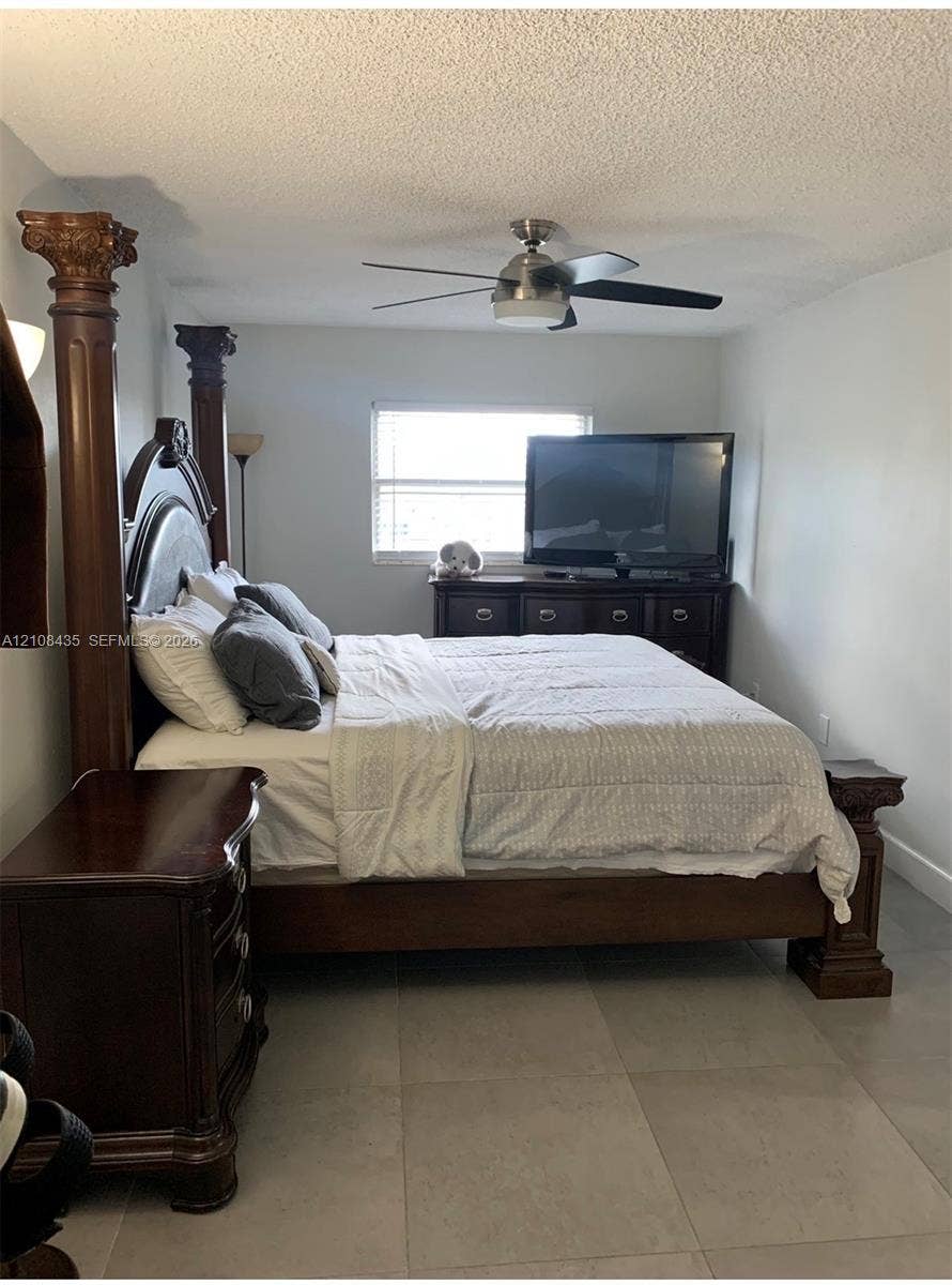 4275 S Tamiami Canal Drive, #2-314, Miami, Miami, FL 33126 Neutral-toned tile flooring, multi-light ceiling fan with a brushed metal finish, and a window with horizontal blinds