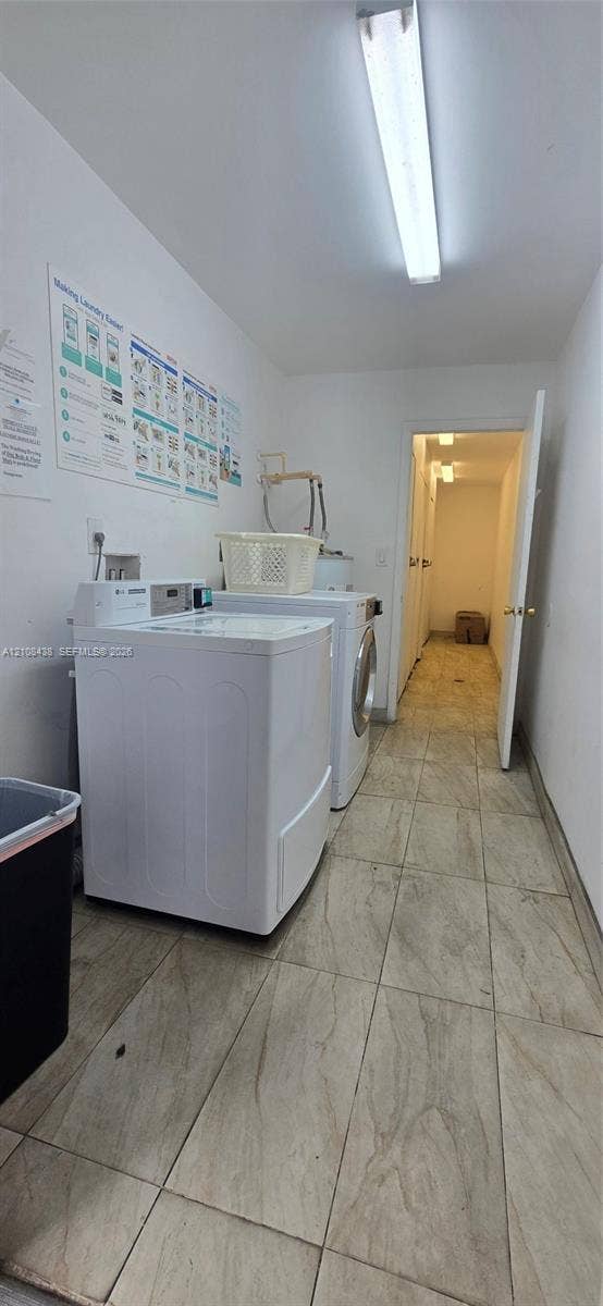 7320 NW 85th Court, #102, Tamarac, FL 33321 Utility space featuring large-format ceramic tile flooring and linear overhead lighting