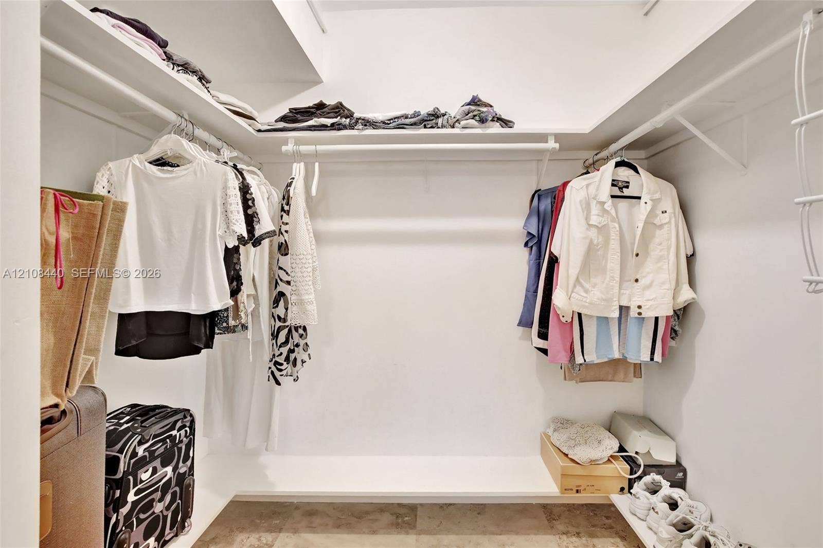 9801 Collins Avenue, #3T, Bal Harbour, Bal Harbour, FL 33154 Walk-in closet featuring tiered shelving, integrated clothing rods, and tile flooring