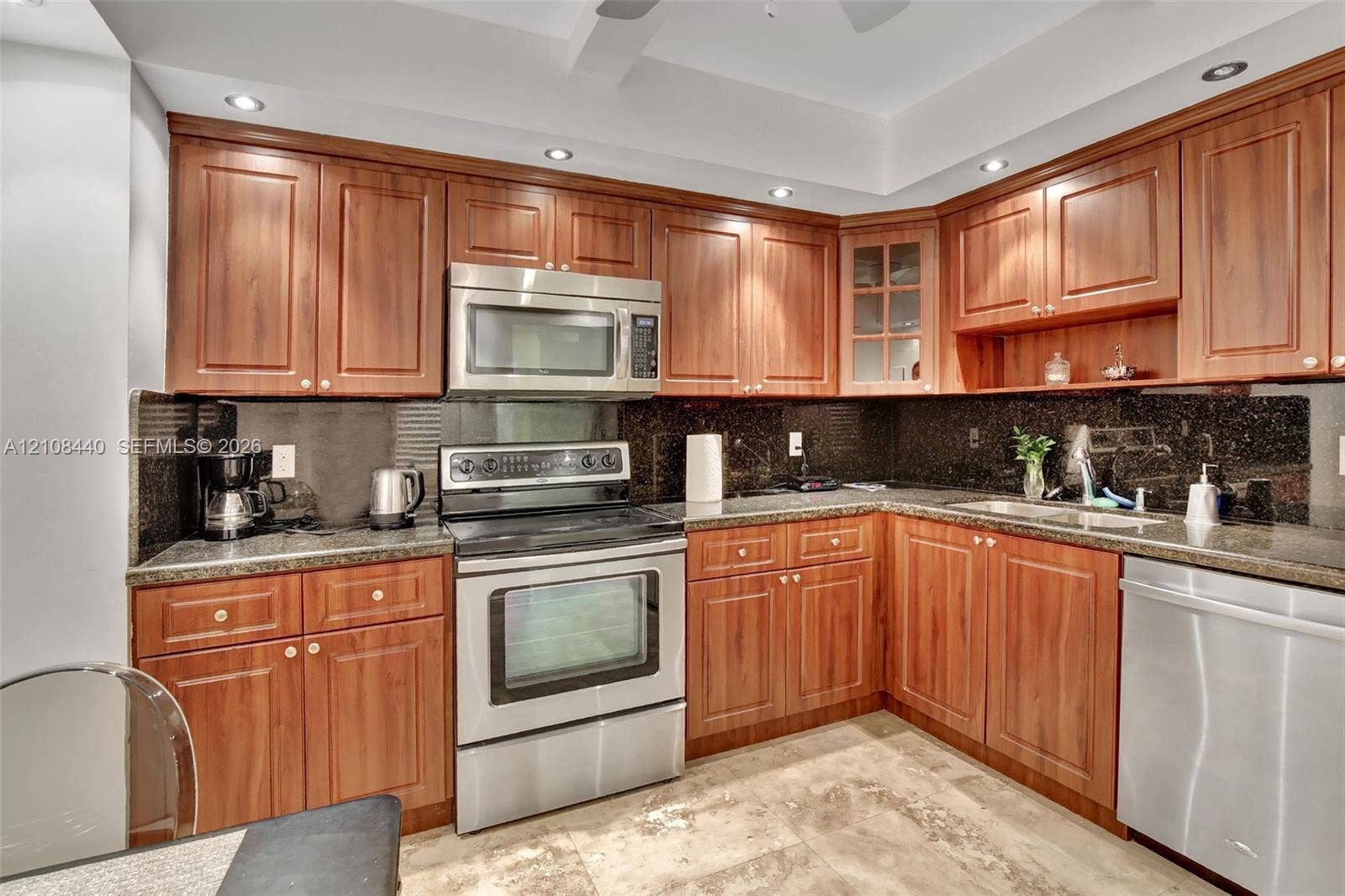 9801 Collins Avenue, #3T, Bal Harbour, Bal Harbour, FL 33154 Kitchen featuring wood cabinetry, stainless steel appliances, dark stone-finish countertops, recessed lighting, and tile flooring