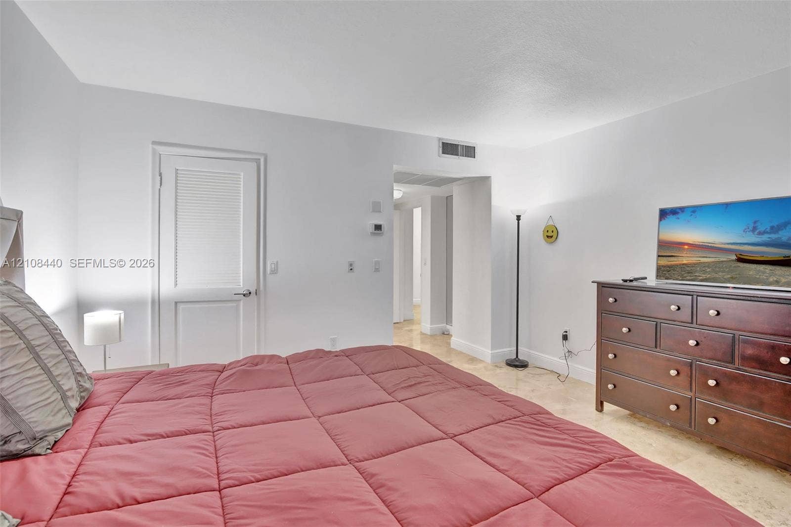 9801 Collins Avenue, #3T, Bal Harbour, Bal Harbour, FL 33154 Neutral interior space featuring polished stone flooring, a single-panel interior door with louvered detail, and smooth-finish walls