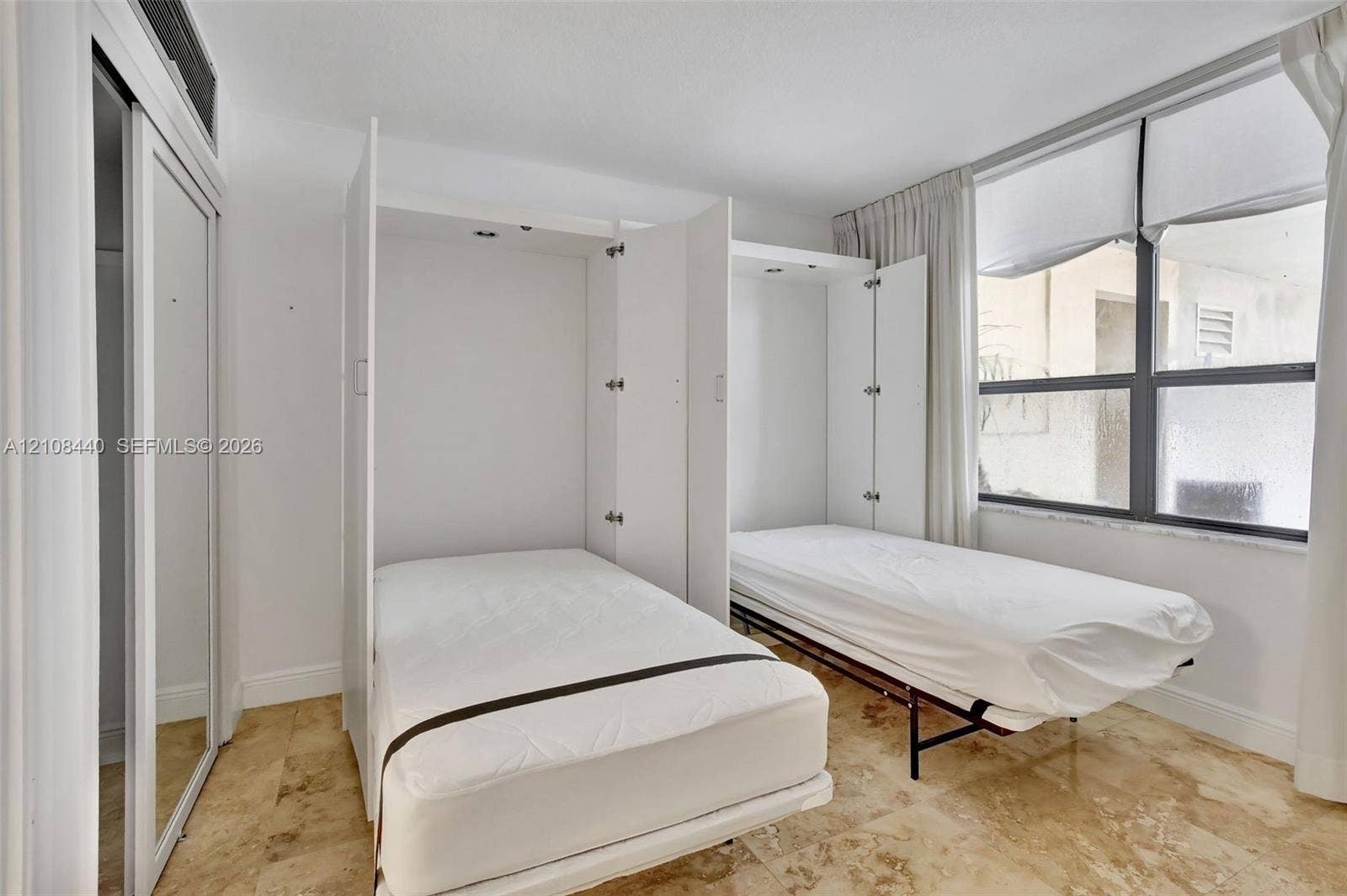 9801 Collins Avenue, #3T, Bal Harbour, Bal Harbour, FL 33154 Built-in dual wall-mounted beds, stone-finish flooring, and sliding-door closets with mirrored panels