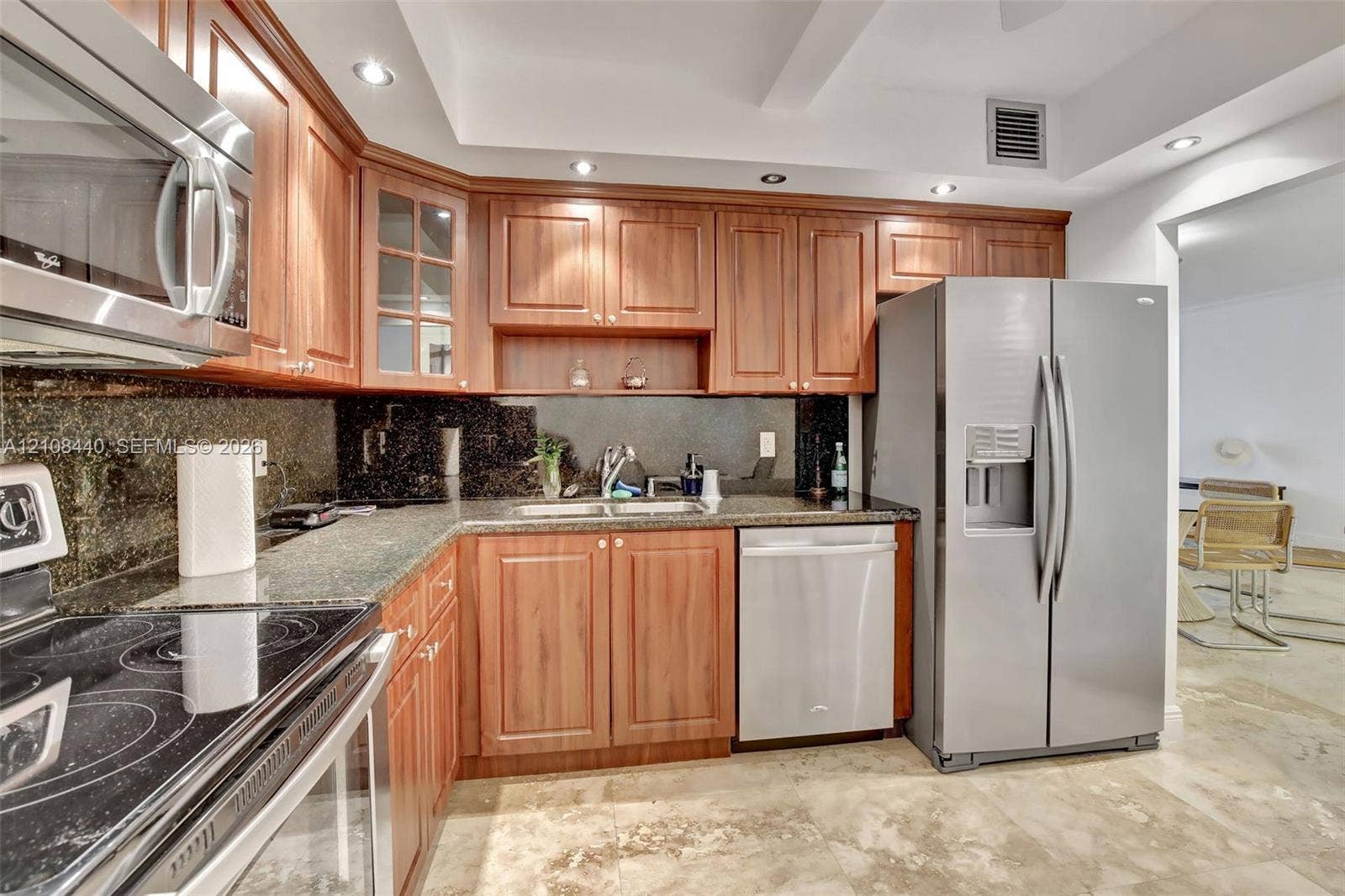 9801 Collins Avenue, #3T, Bal Harbour, Bal Harbour, FL 33154 Kitchen featuring wood cabinetry, stone countertops, dark stone backsplash, stainless steel appliances, and recessed lighting
