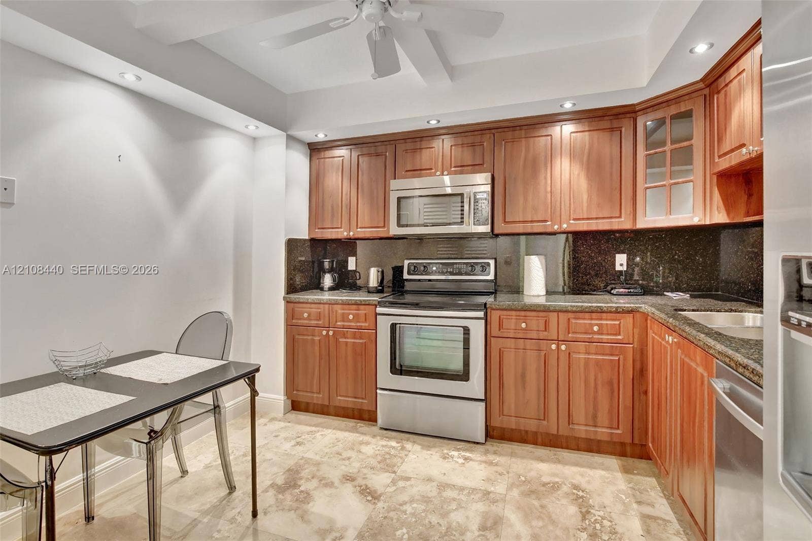 9801 Collins Avenue, #3T, Bal Harbour, Bal Harbour, FL 33154 Kitchen featuring natural wood cabinetry, stone countertops, stainless steel appliances, and tile flooring with recessed lighting