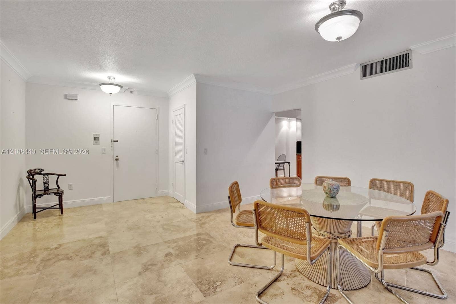 9801 Collins Avenue, #3T, Bal Harbour, Bal Harbour, FL 33154 Neutral stone tile flooring, crown molding, and two semi-flush mount ceiling light fixtures