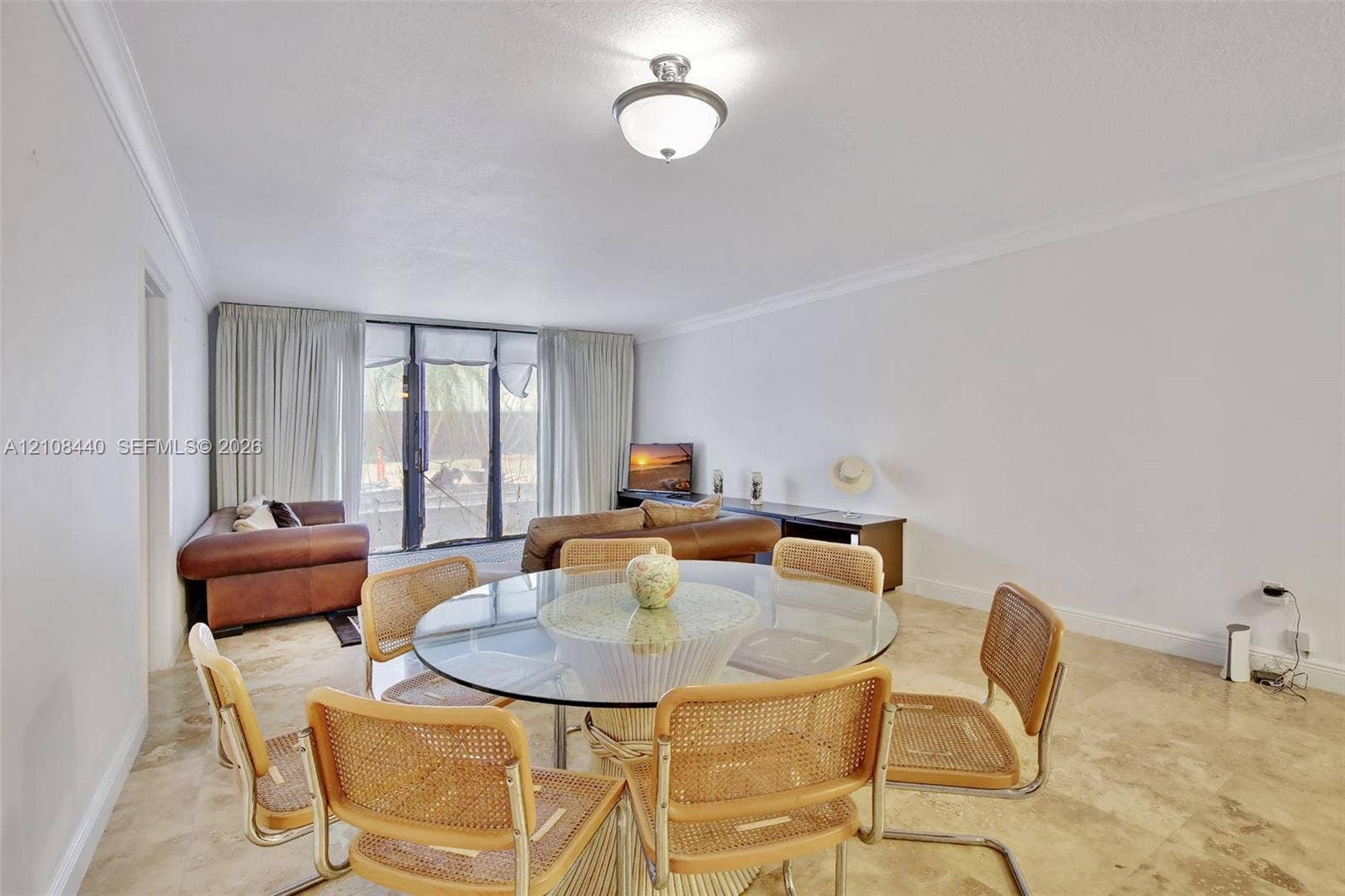 9801 Collins Avenue, #3T, Bal Harbour, Bal Harbour, FL 33154 Neutral stone flooring, crown molding, and floor-to-ceiling glass sliding doors