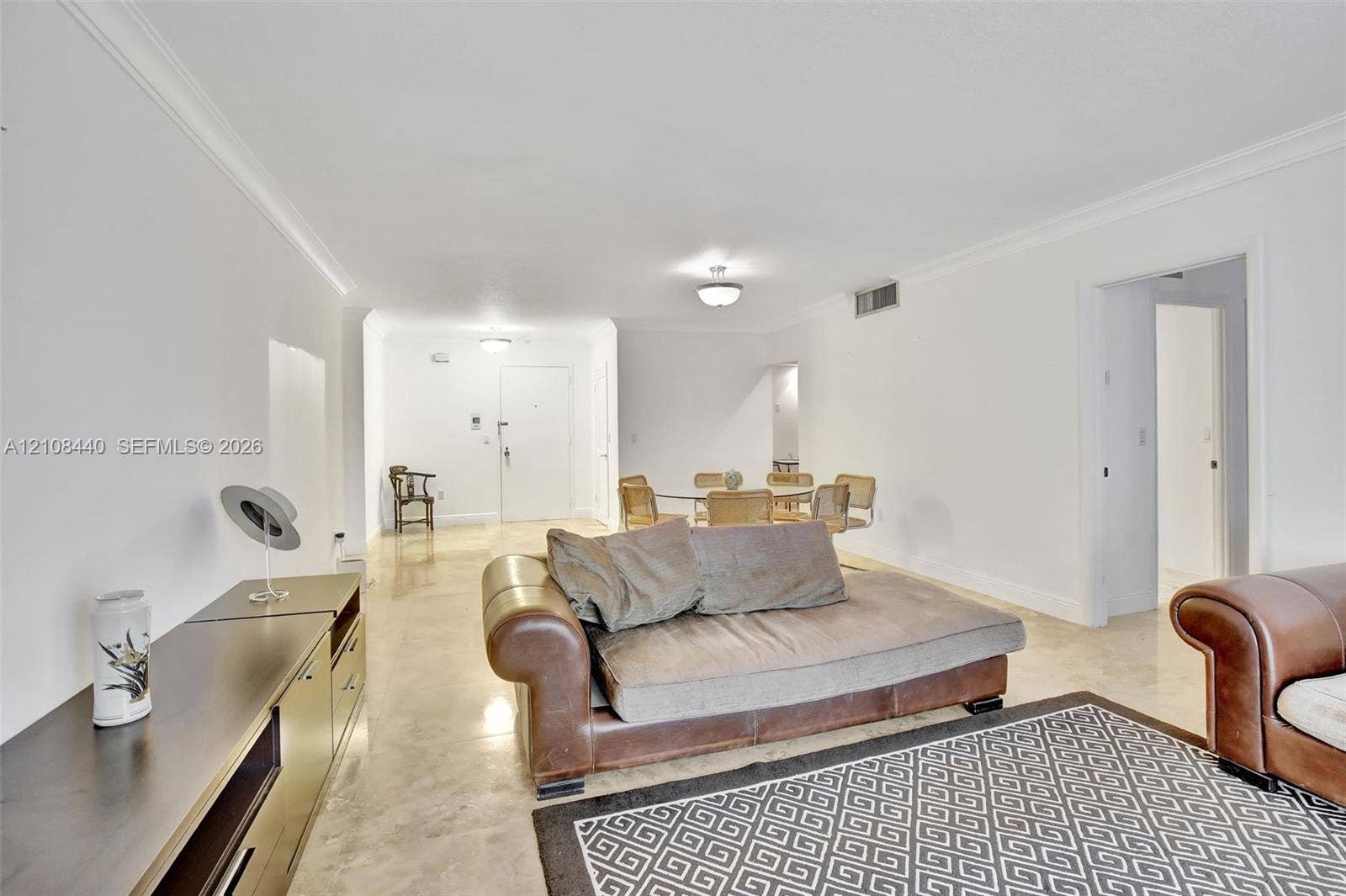 9801 Collins Avenue, #3T, Bal Harbour, Bal Harbour, FL 33154 Open-concept interior featuring smooth-finish tile flooring, recessed crown molding, and neutral wall tones