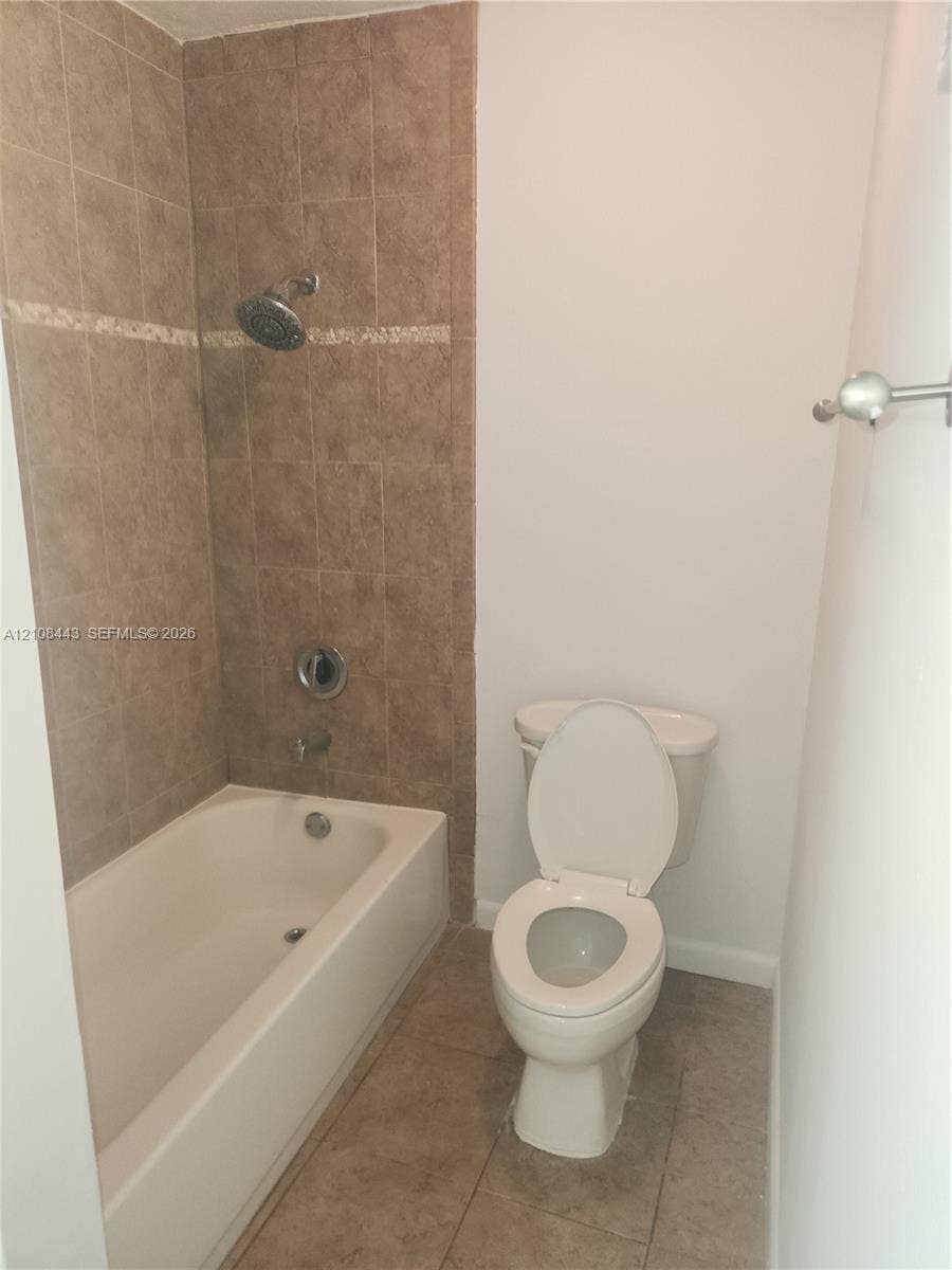 4018 NW 87th Avenue, #4018, Sunrise, Sunrise, FL 33351 Bathtub with tile surround, decorative accent inlay, wall-mounted showerhead, and tile flooring