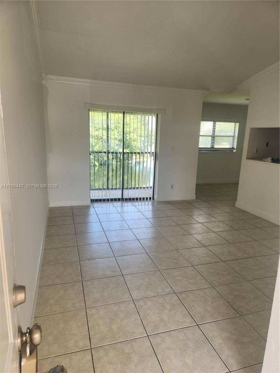 4018 NW 87th Avenue, #4018, Sunrise, Sunrise, FL 33351 Neutral-toned ceramic tile flooring, floor-to-ceiling sliding glass doors, and a built-in architectural wall cutout