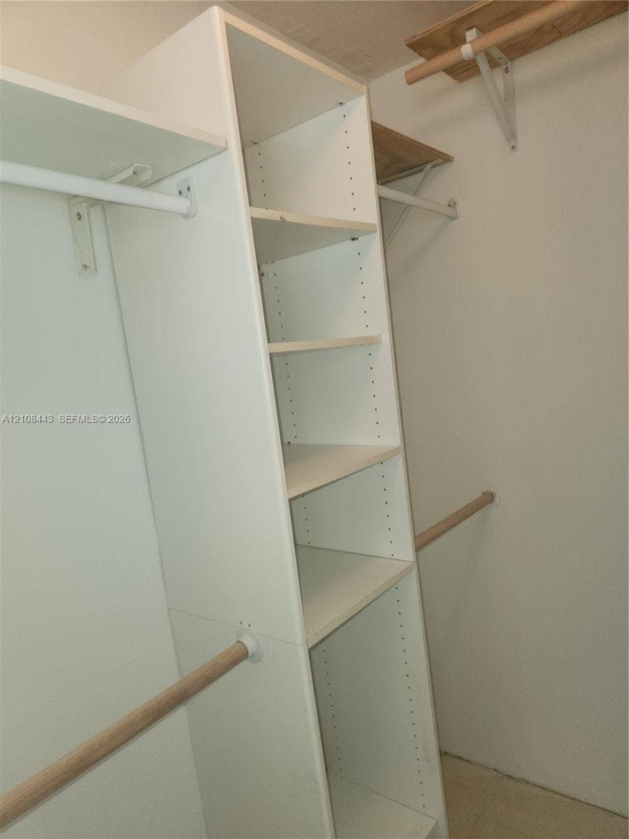 4018 NW 87th Avenue, #4018, Sunrise, Sunrise, FL 33351 Built-in white storage shelving unit with multiple tiers and dual wooden clothing rods