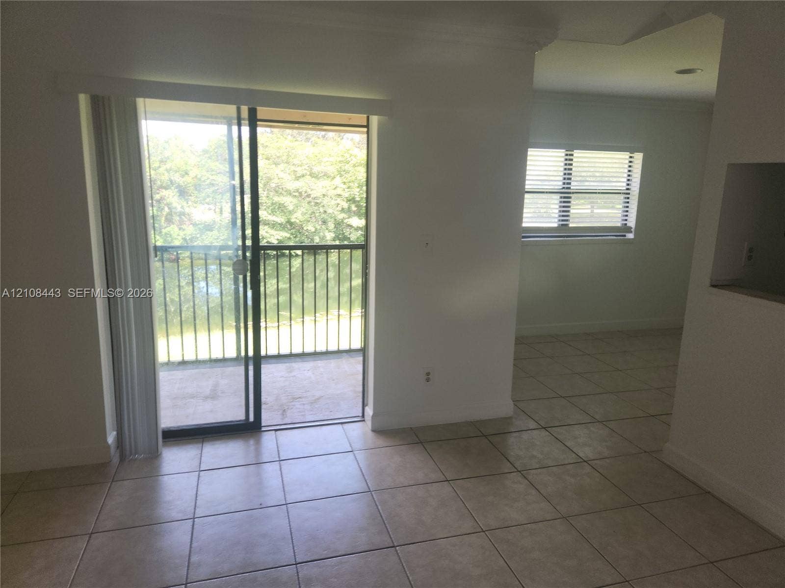 4018 NW 87th Avenue, #4018, Sunrise, Sunrise, FL 33351 Tile flooring, sliding glass door, and covered balcony with metal railing
