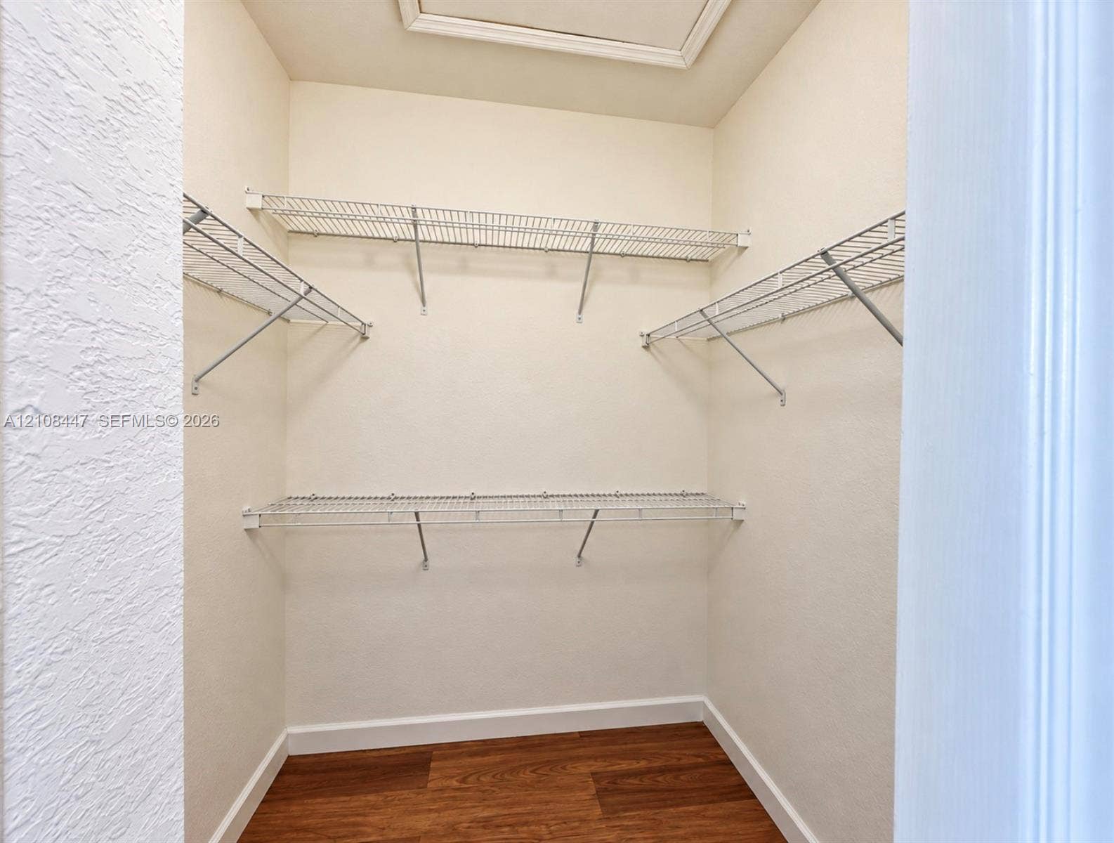 Storage area featuring wood-finish flooring and tiered wire shelving units