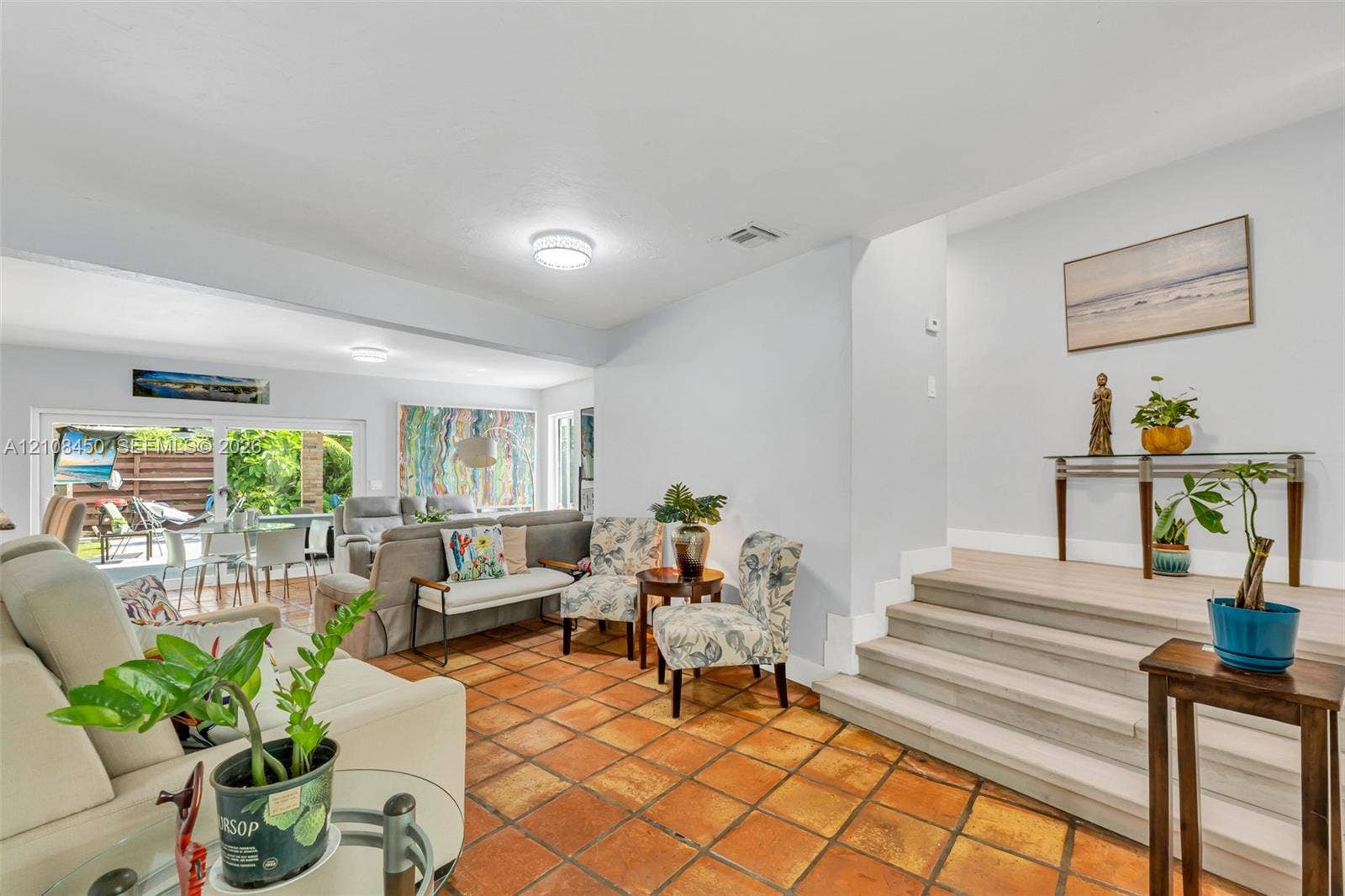 Terracotta tile flooring and elevated wood-finish staircase