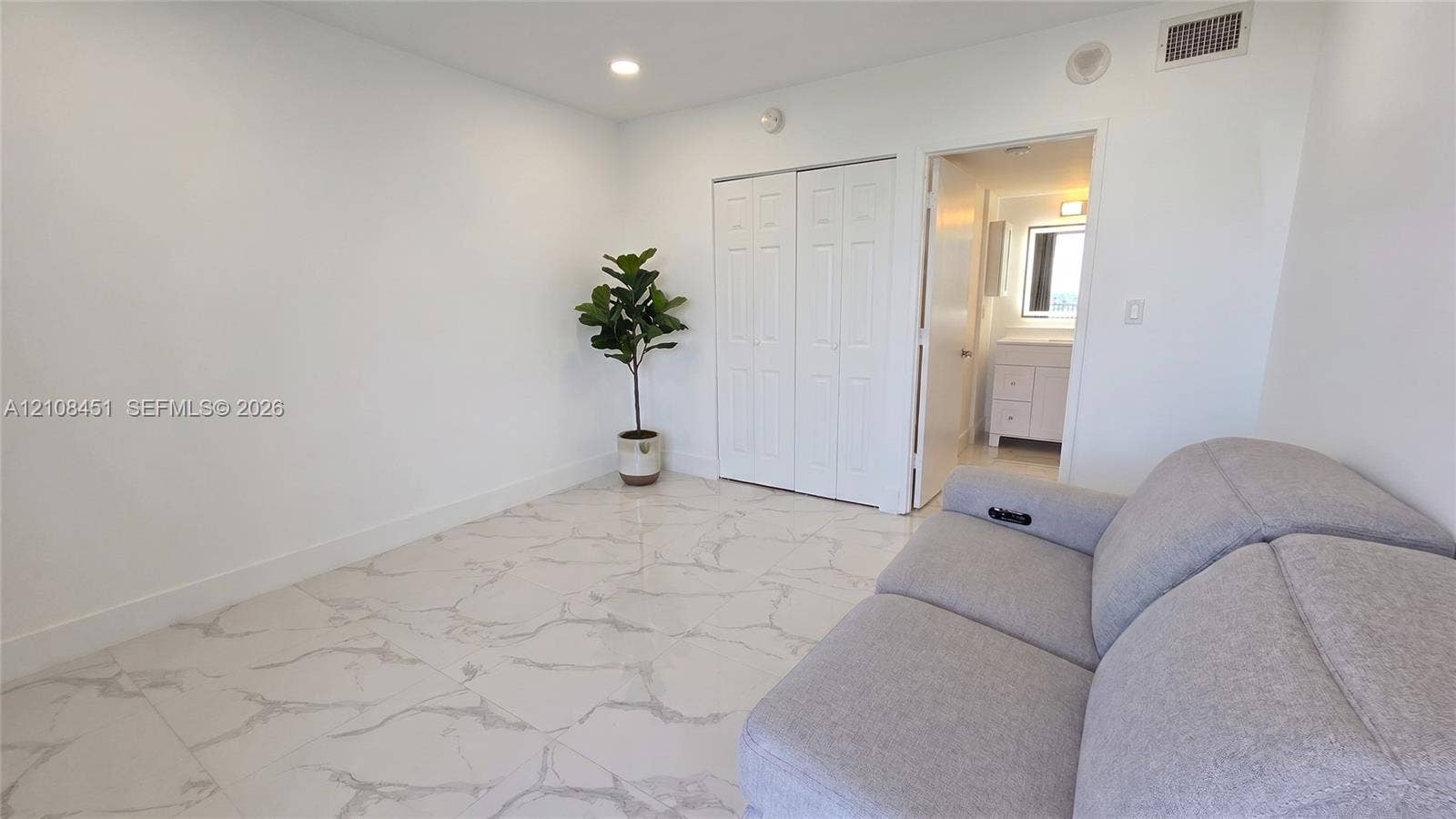 3701 N Country Club Drive, #701, Aventura, Aventura, FL 33180 Interior space featuring large-format veined tile flooring, recessed lighting, and double-door closet cabinetry