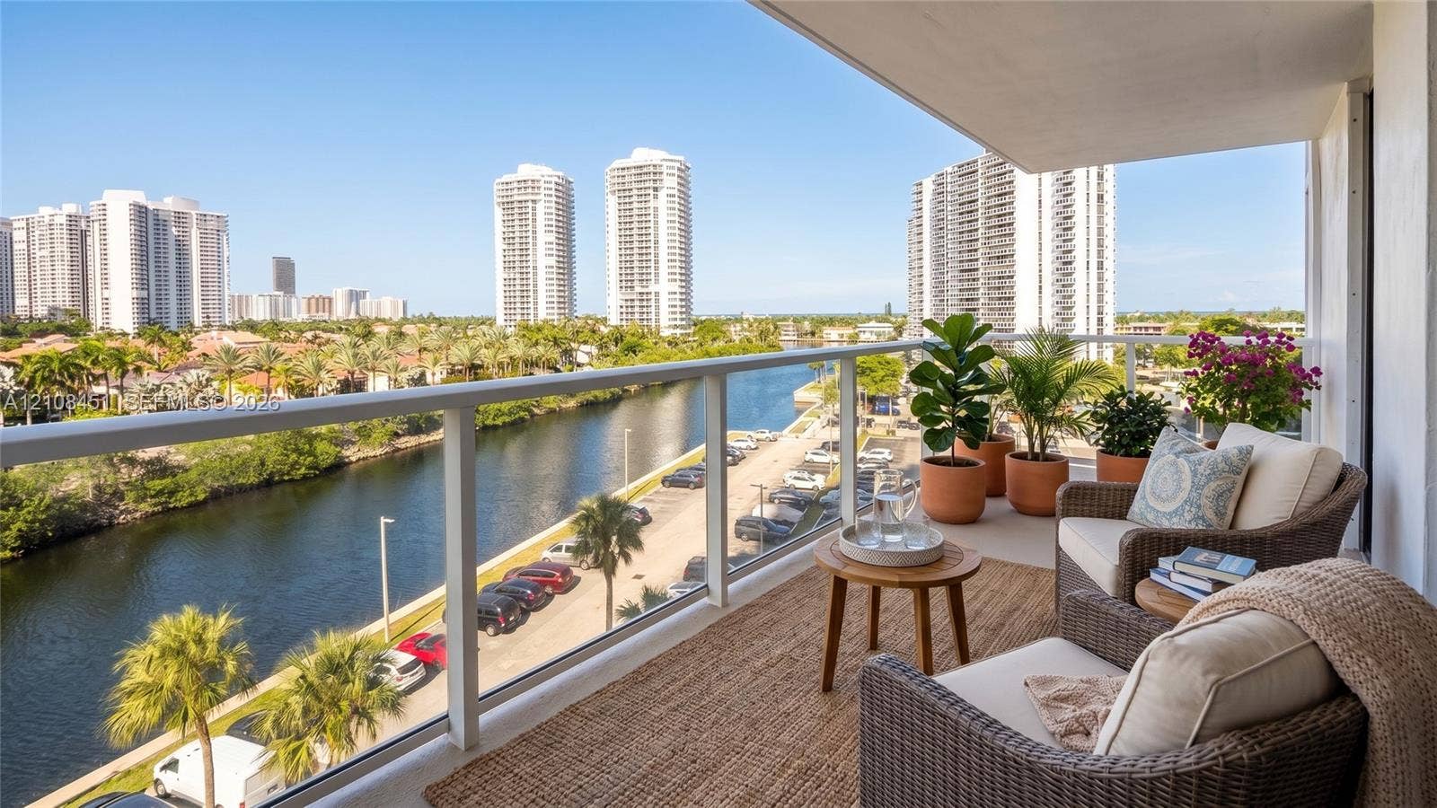 3701 N Country Club Drive, #701, Aventura, Aventura, FL 33180 Covered balcony featuring glass railing and concrete flooring with water and urban skyline backdrop