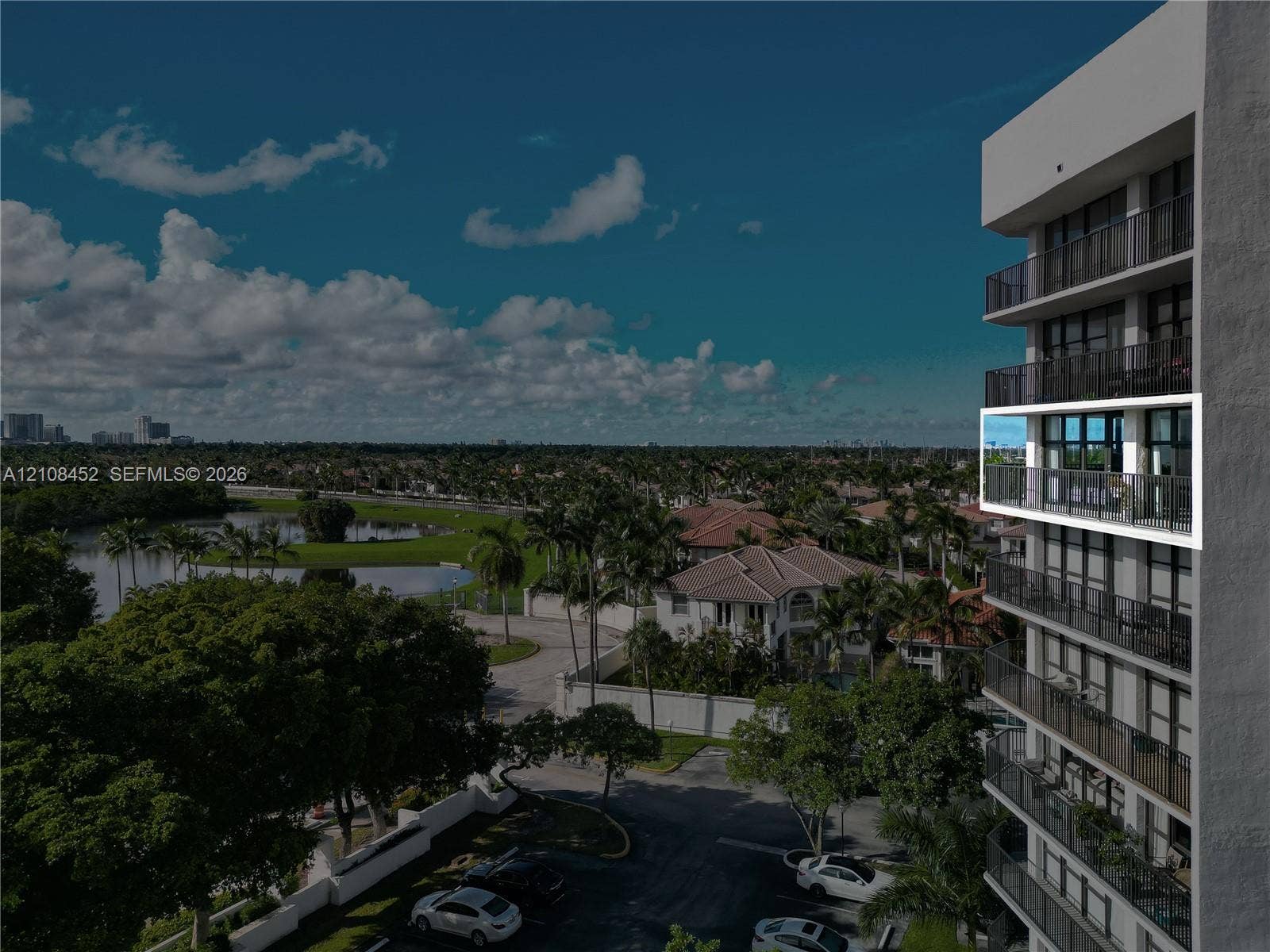 1000 Parkview Drive, #809, Hallandale Beach, FL 33009 High-rise building exterior featuring private balconies with black metal railings and floor-to-ceiling glass doors