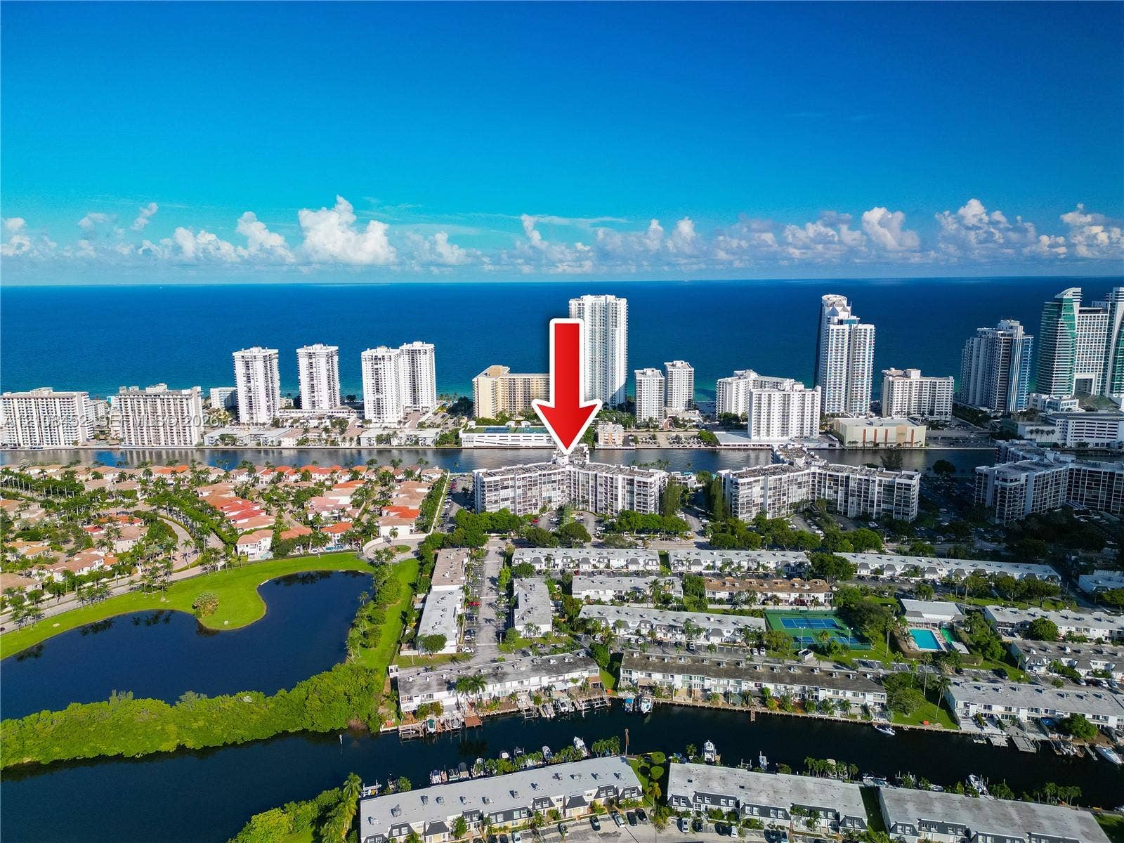1000 Parkview Drive, #809, Hallandale Beach, FL 33009 Aerial perspective of waterfront residential complex featuring multiple mid-rise buildings, canal-front positioning, and proximity to the coastline