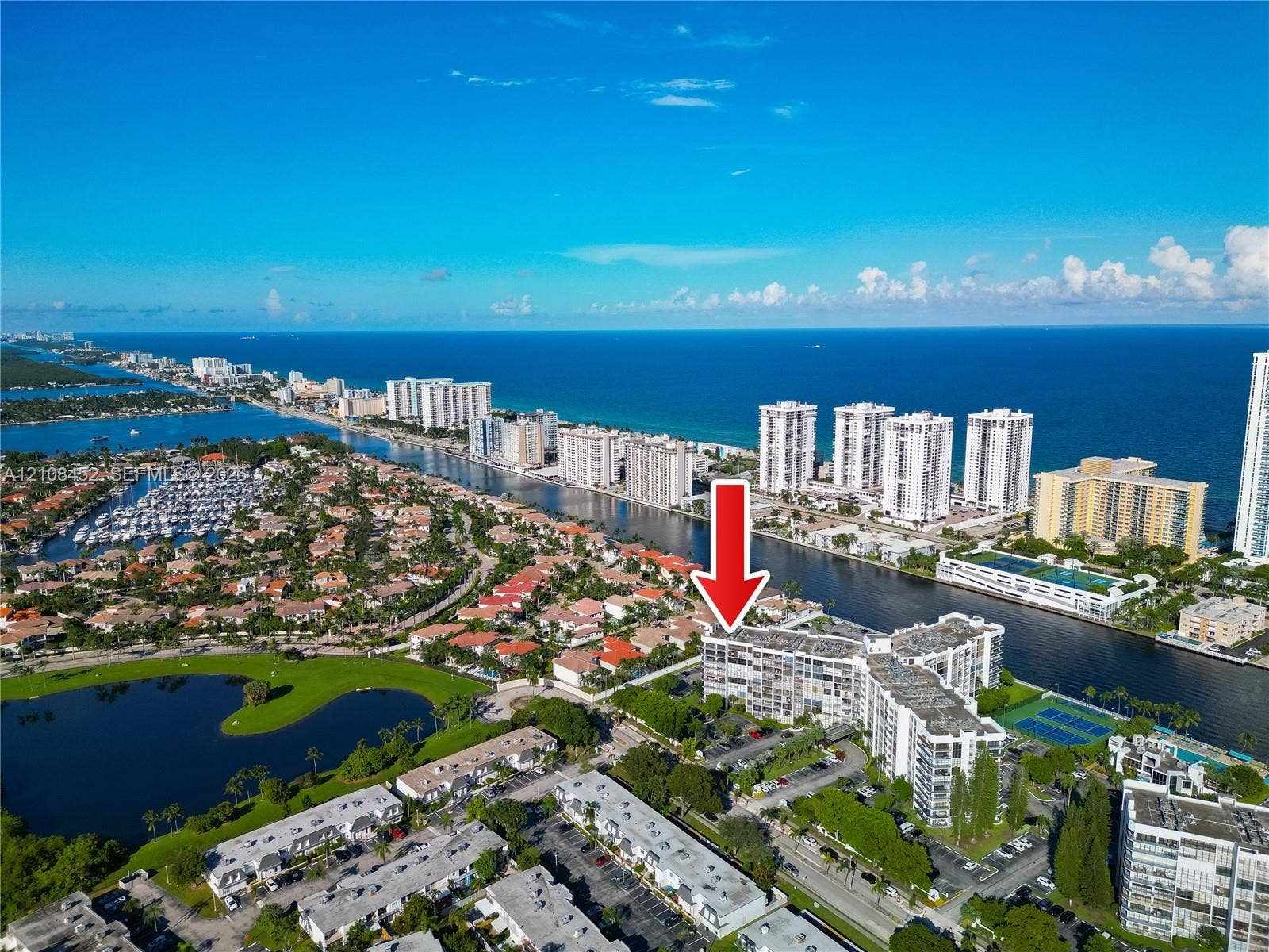 1000 Parkview Drive, #809, Hallandale Beach, FL 33009 Aerial perspective of a multi-story residential building featuring proximity to coastal waterways and access to tennis courts