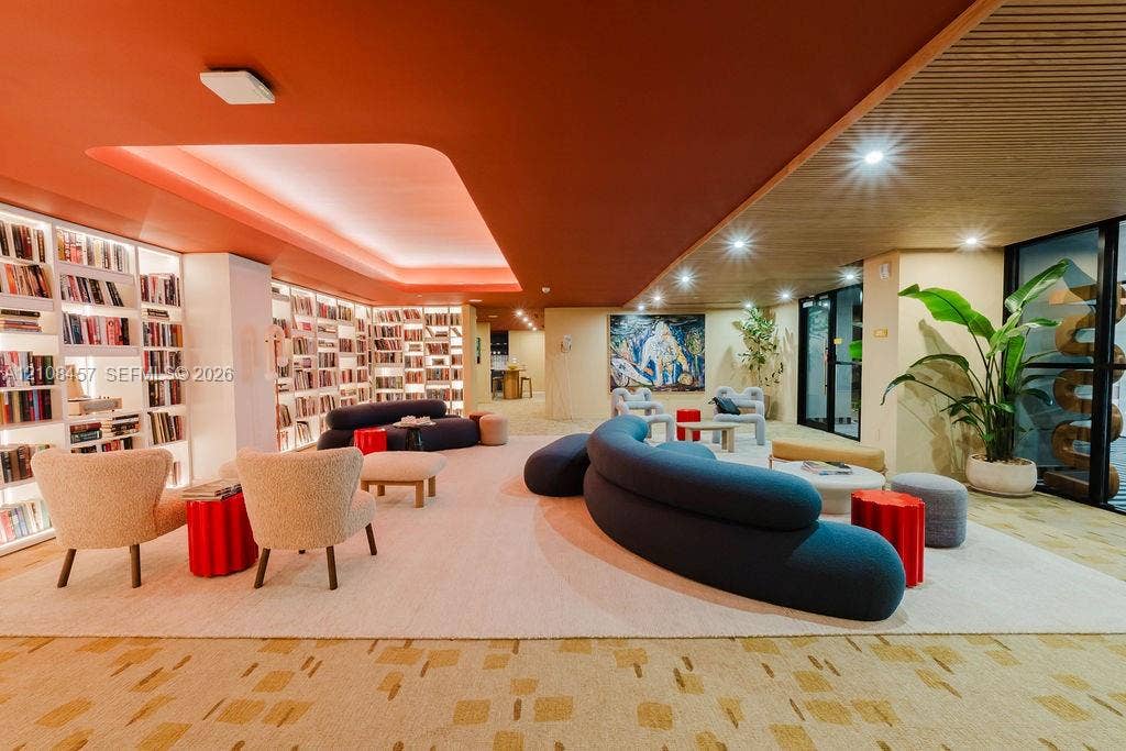 90 NE 32nd Street, #511, Miami, FL 33127 Floor-to-ceiling built-in bookcases with integrated lighting, recessed tray ceiling, wood-slat ceiling accent, and recessed lighting