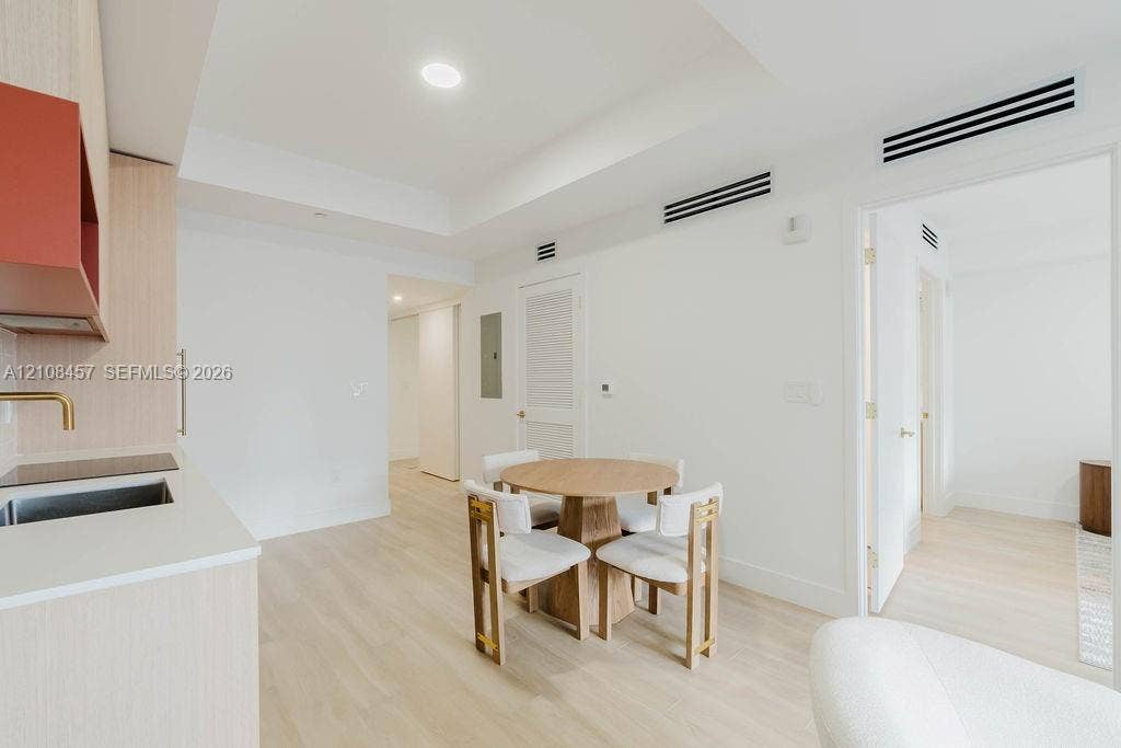 90 NE 32nd Street, #511, Miami, FL 33127 Light wood-finish flooring, recessed lighting, matte-finish solid surface countertops, metallic-finish faucet, and clean-lined cabinetry