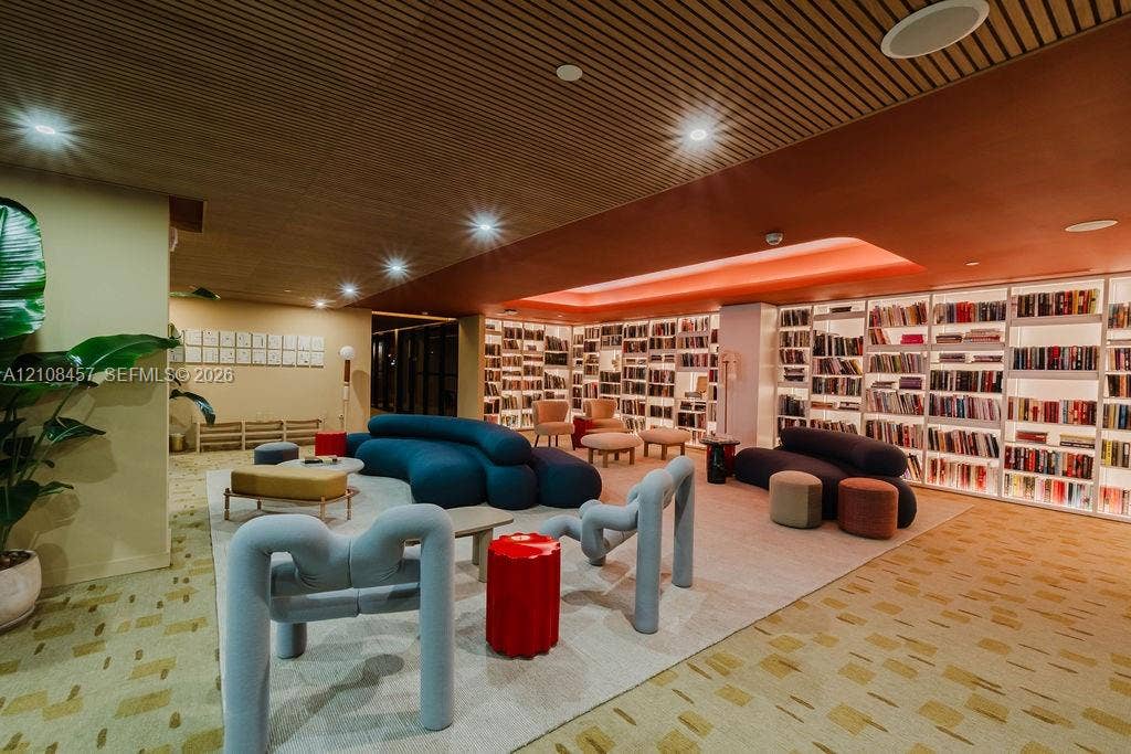 90 NE 32nd Street, #511, Miami, FL 33127 Slatted wood-plank ceiling featuring recessed lighting, expansive wall-to-wall built-in shelving, and integrated cove lighting
