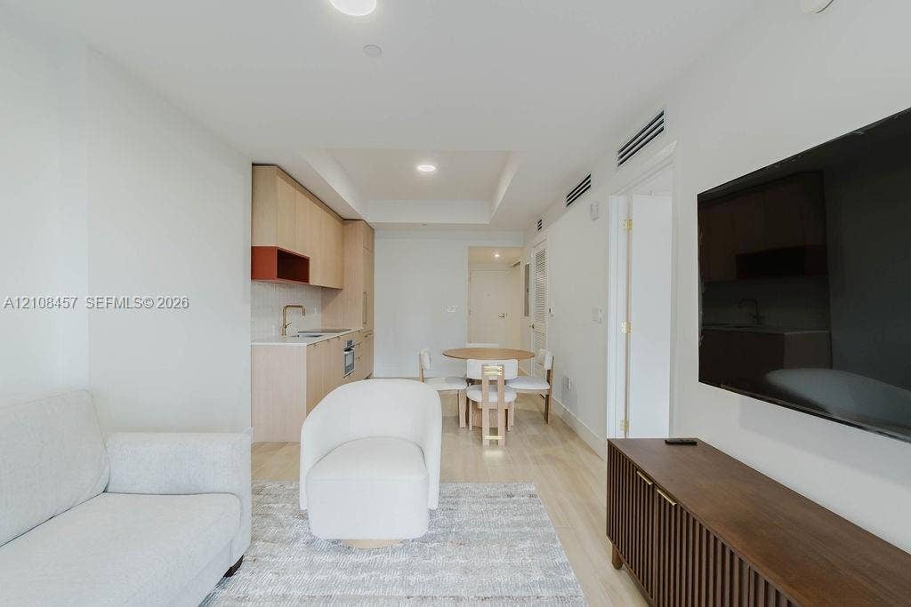 90 NE 32nd Street, #511, Miami, FL 33127 Light-toned wood-finish flooring, recessed lighting, and kitchen featuring flat-panel cabinetry with contrasting shelving