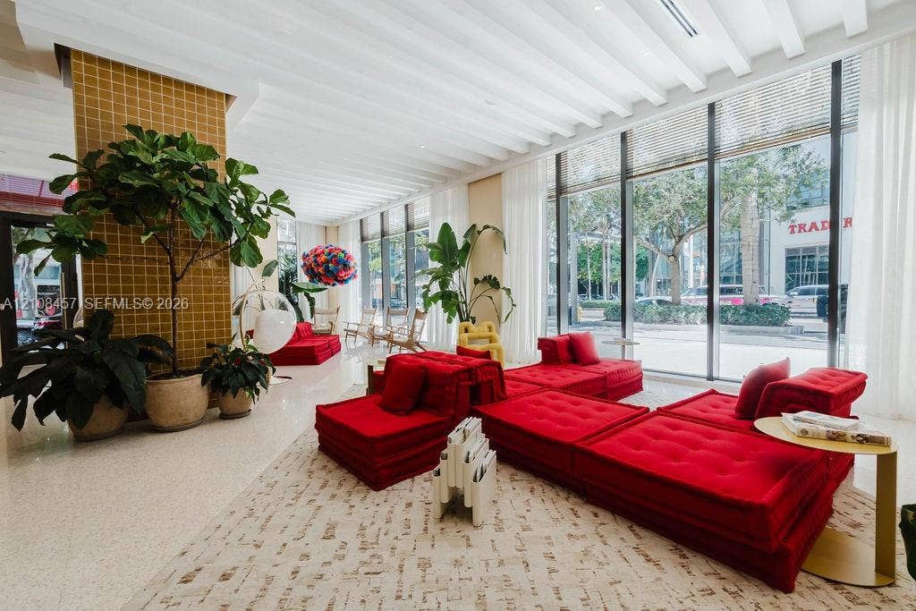 90 NE 32nd Street, #511, Miami, FL 33127 Floor-to-ceiling glass windows, ribbed ceiling detailing, tile-accented structural column, and polished stone flooring