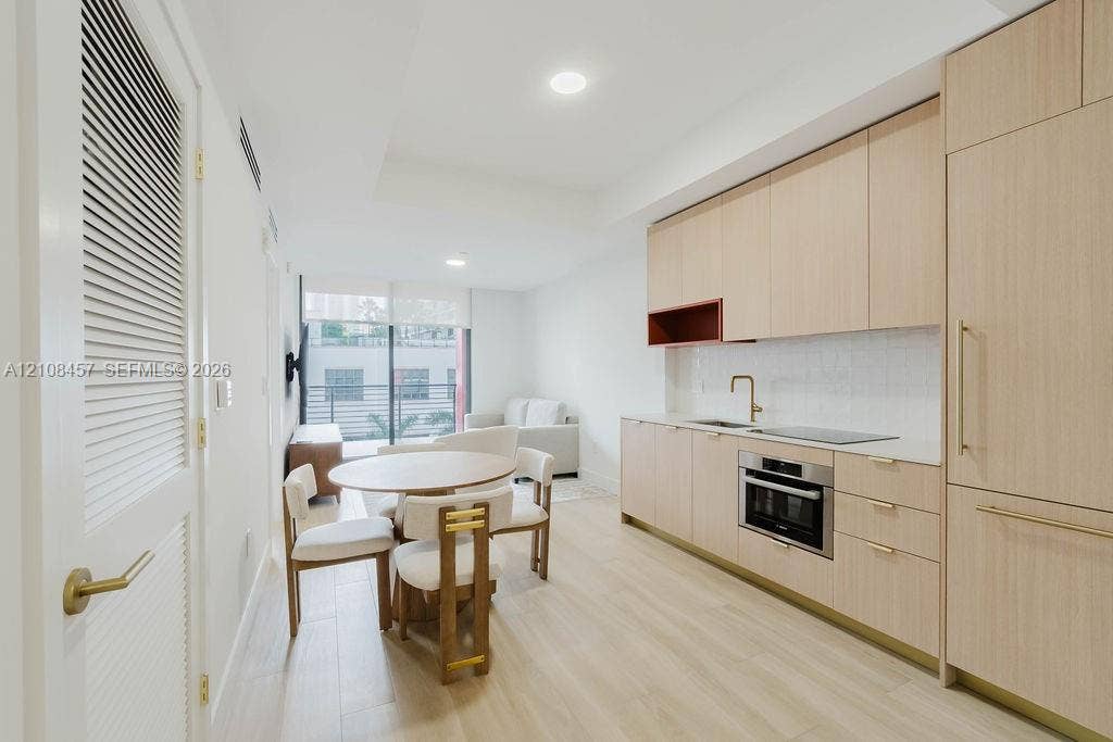 90 NE 32nd Street, #511, Miami, FL 33127 Kitchen featuring light wood-finish cabinetry, quartz countertops, an integrated refrigerator, recessed lighting, and wood-finish flooring