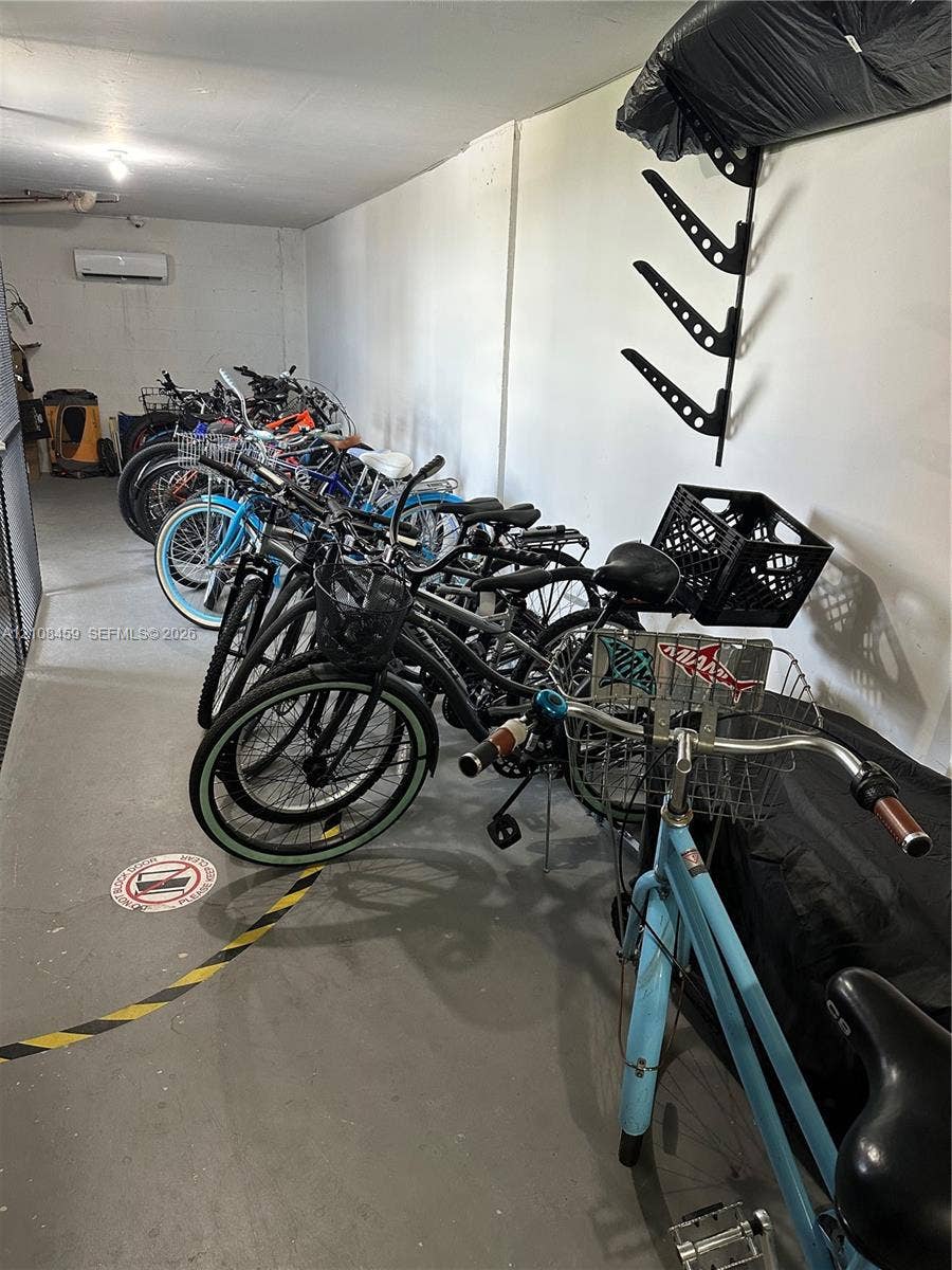 720 Collins Avenue, #206, Miami Beach, Miami Beach, FL 33139 Enclosed storage space featuring a wall-mounted rack system and a dedicated climate-control unit