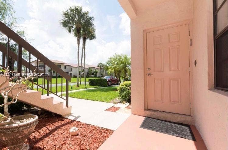 21362 Juego Circle, #33E, Boca Raton, Boca Raton, FL 33433 Covered entryway with a four-panel entry door