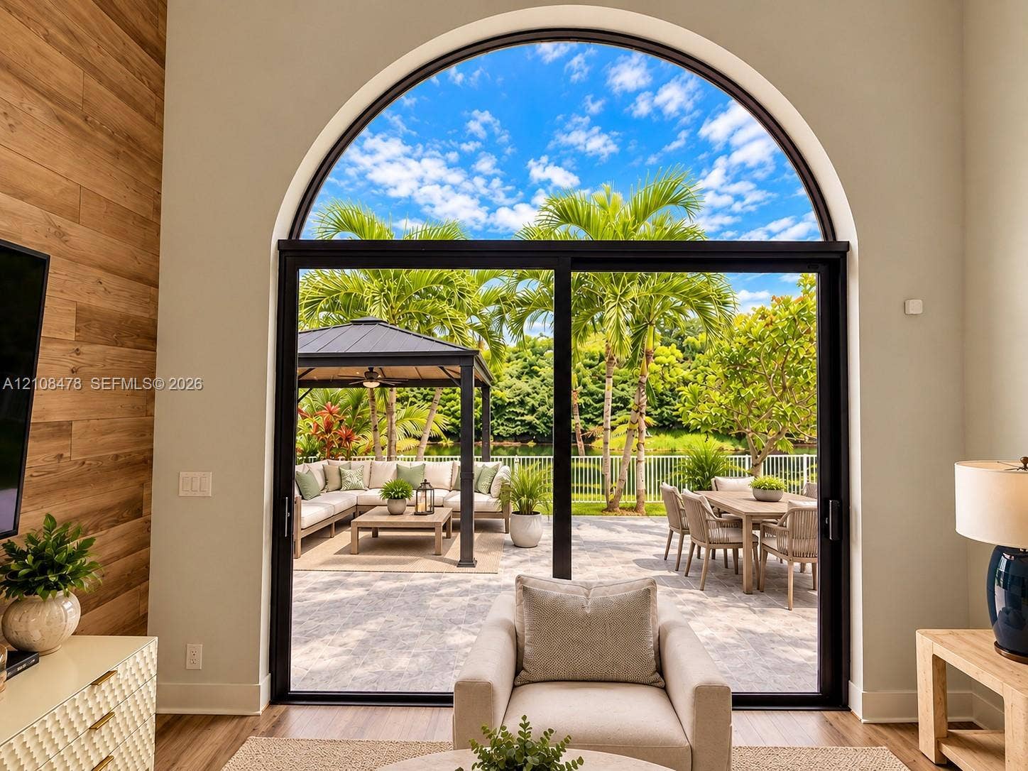 2233 NW 162nd Terrace, Pembroke Pines, FL 33028 Stucco exterior featuring an arched entryway, double-door entrance, stone-paver driveway, and gabled roofline