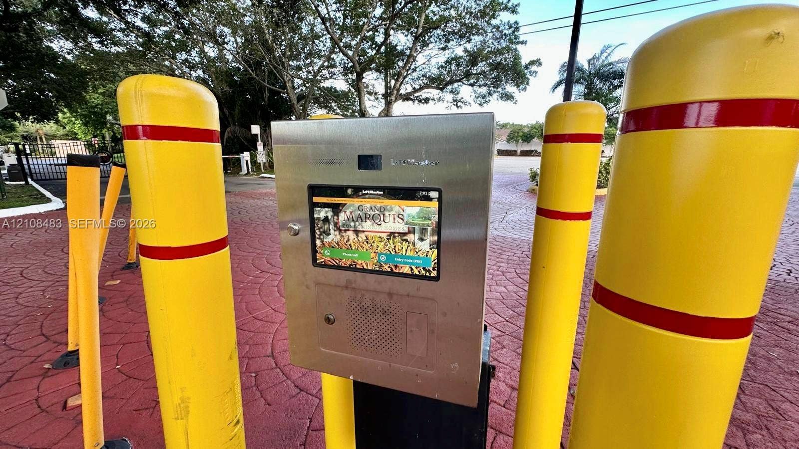 10121 W Sunrise Boulevard, #204, Plantation, Plantation, FL 33322 Electronic gated entry system with stainless steel housing, integrated digital touchscreen interface, and protective yellow bollards