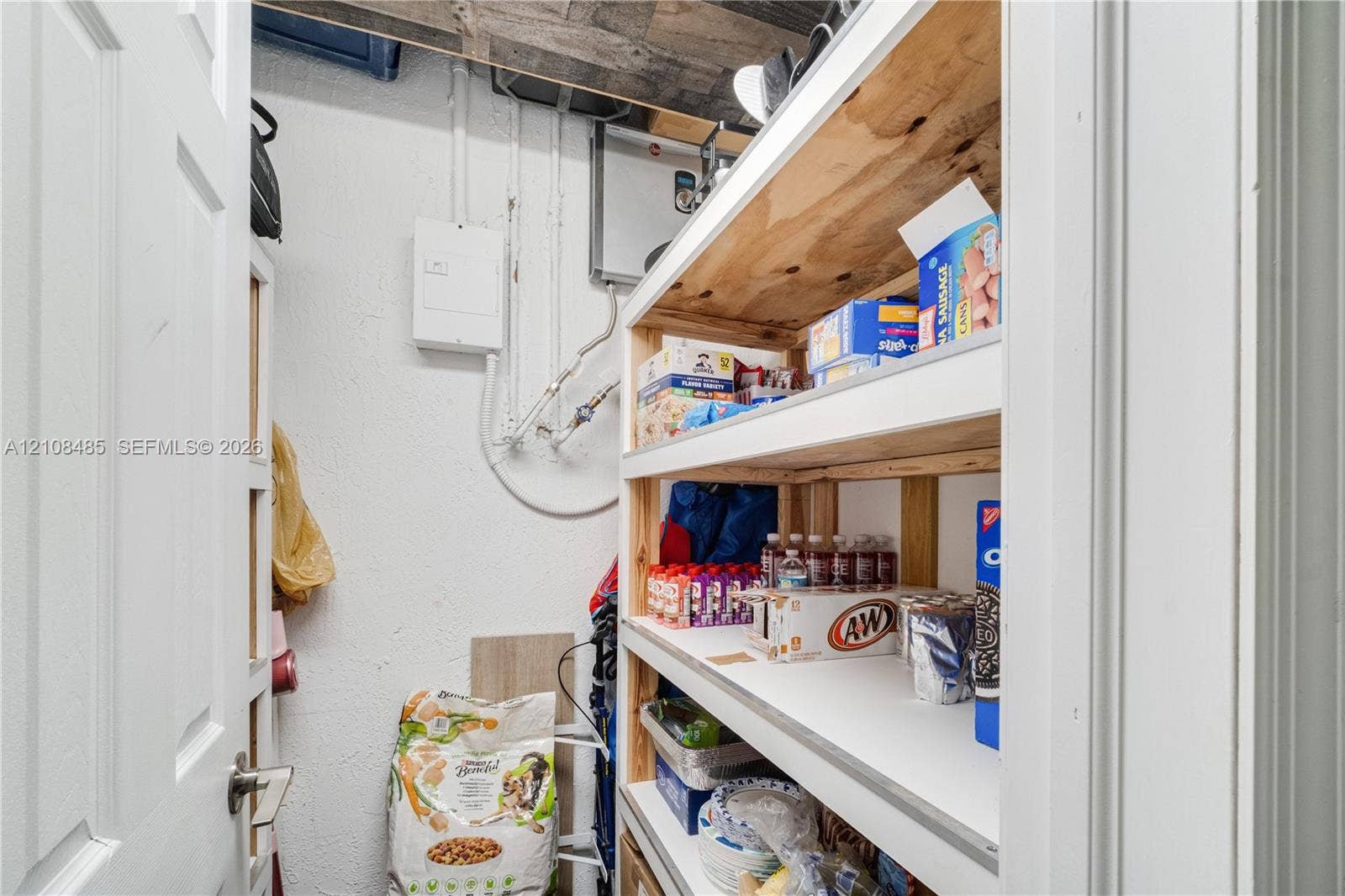 10217 SW 231st Lane, Miami, FL 33190 Storage space featuring custom-built wood shelving units and white painted walls