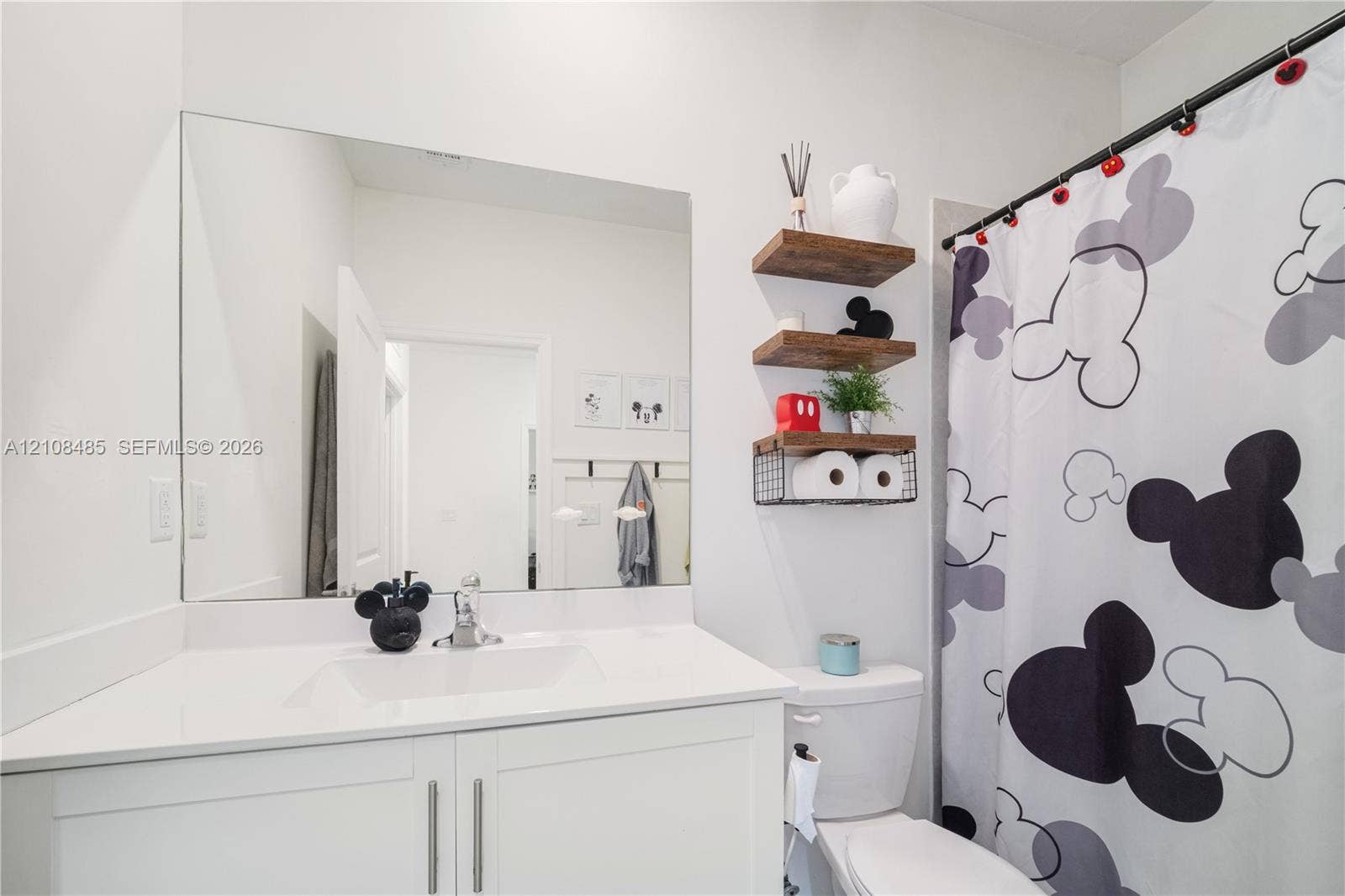 10217 SW 231st Lane, Miami, FL 33190 White vanity with a rectangular undermount sink, countertop, and a large frameless wall-mounted mirror