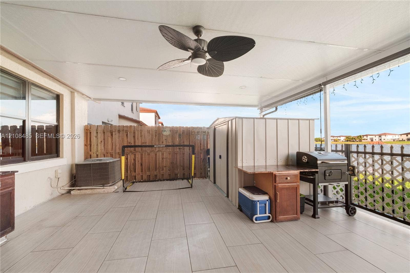 10217 SW 231st Lane, Miami, FL 33190 Covered patio featuring ceramic tile flooring, a ceiling fan, and metal lattice screening