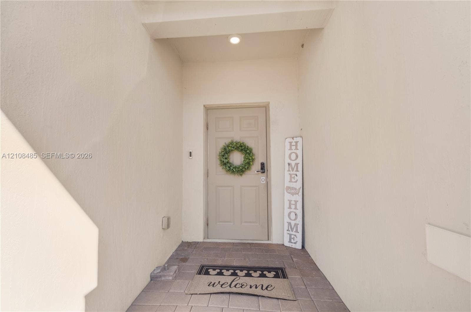 10217 SW 231st Lane, Miami, FL 33190 Covered entryway featuring smooth wall finishes, recessed lighting, and paver stone flooring